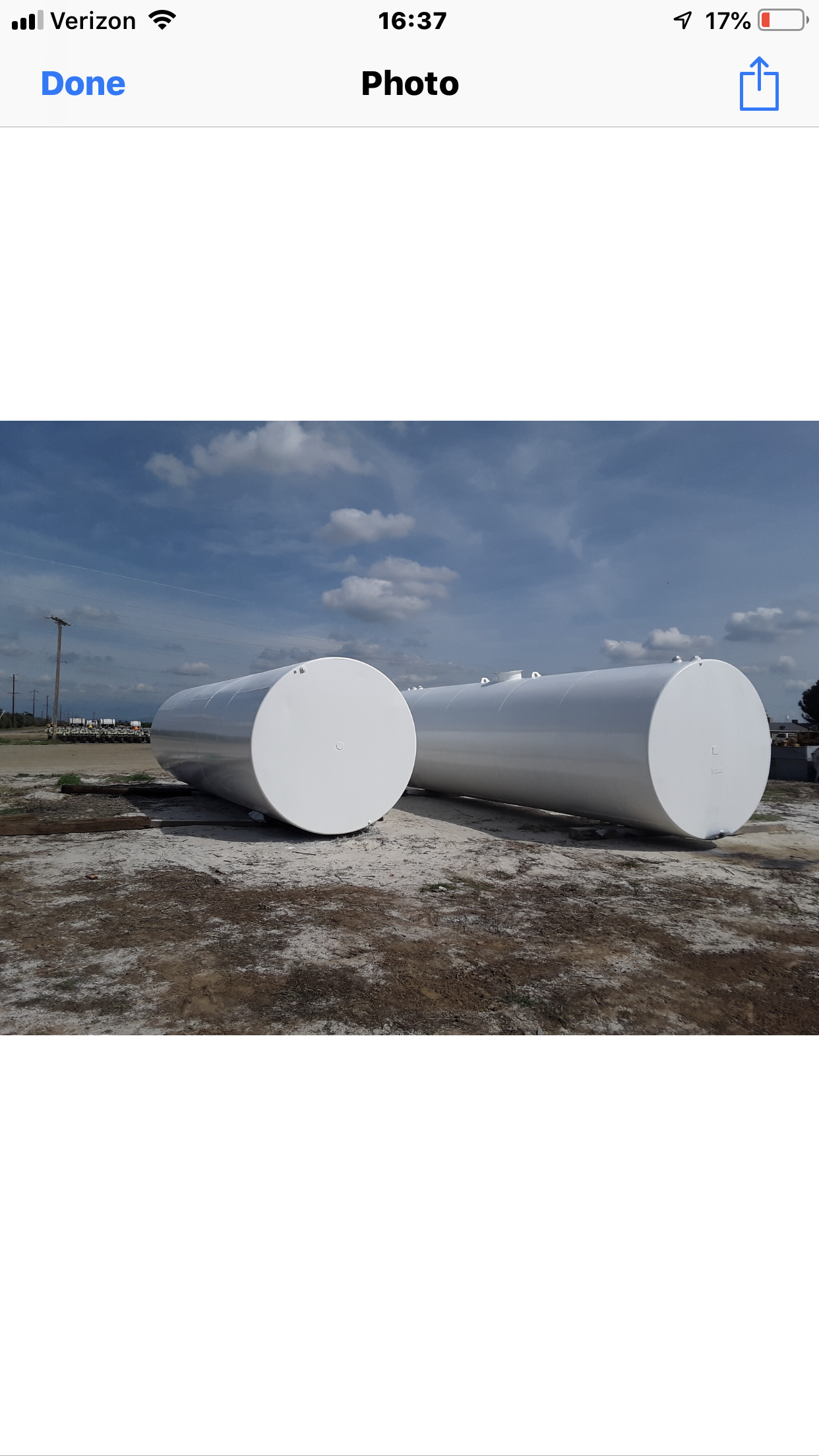 Two horizontal storage tanks coated white after surface preparation