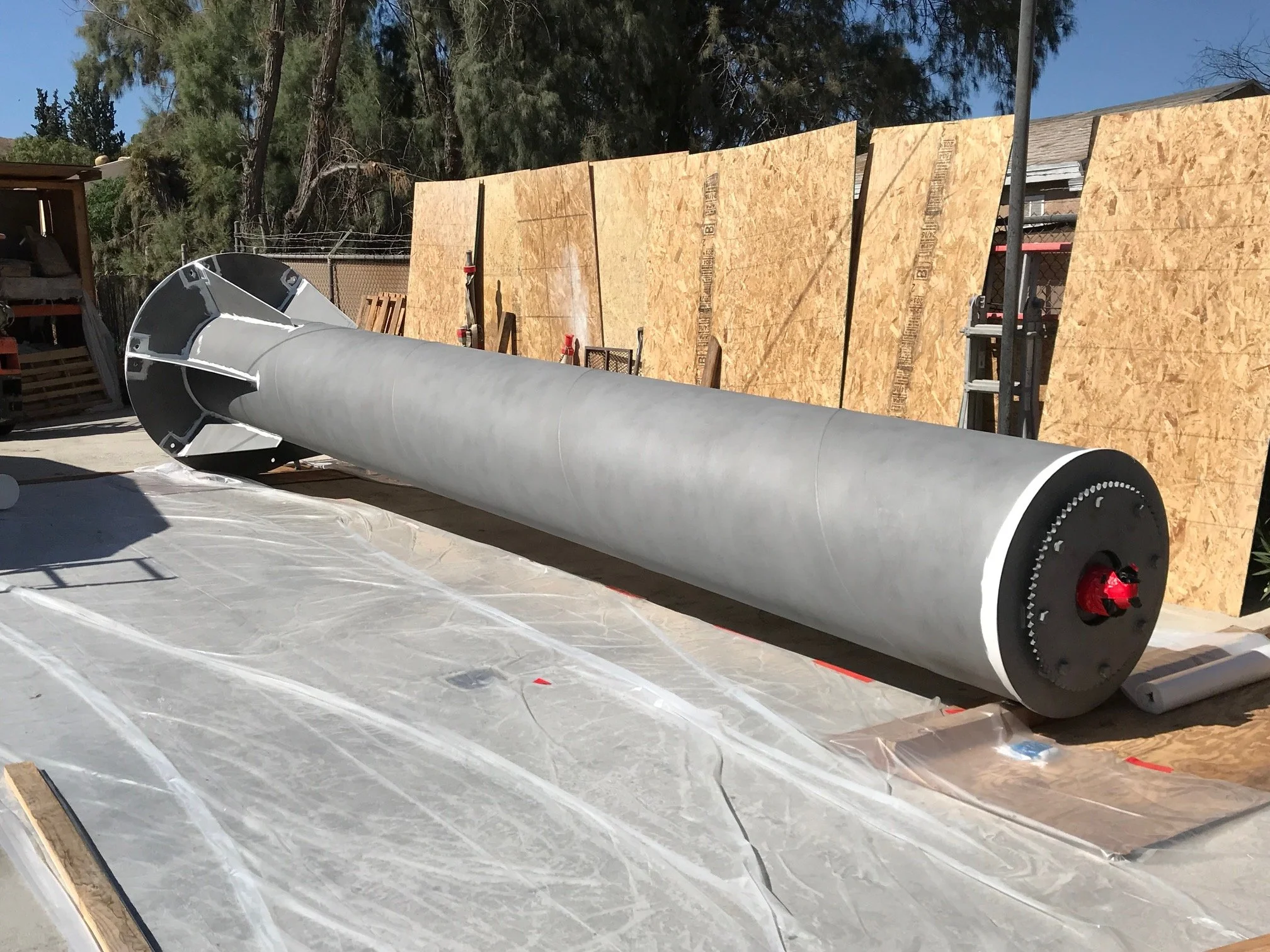 Steel crane mast blasted to bare metal in the shop yard