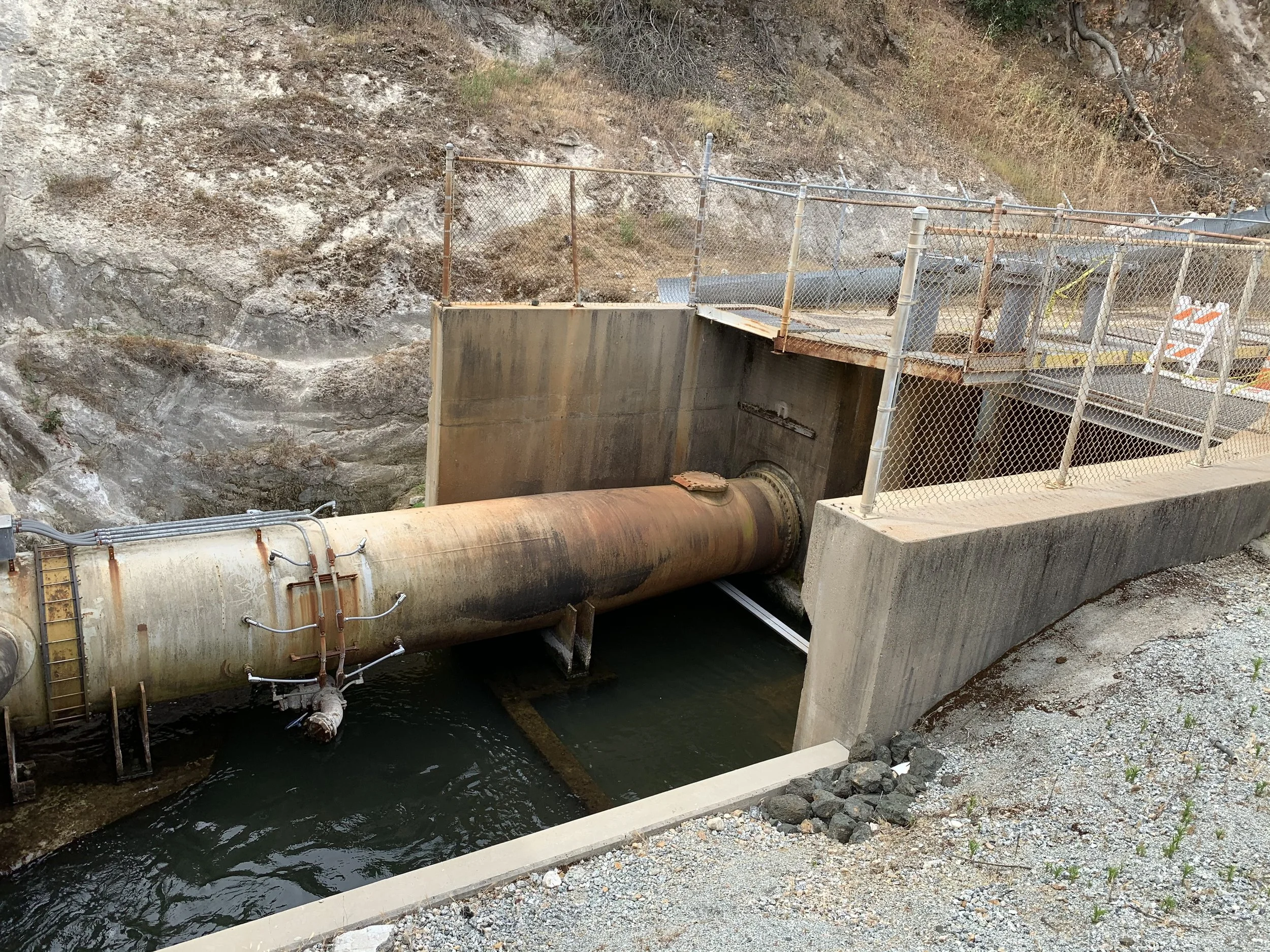 Corroded steel pipe at a concrete water control structure