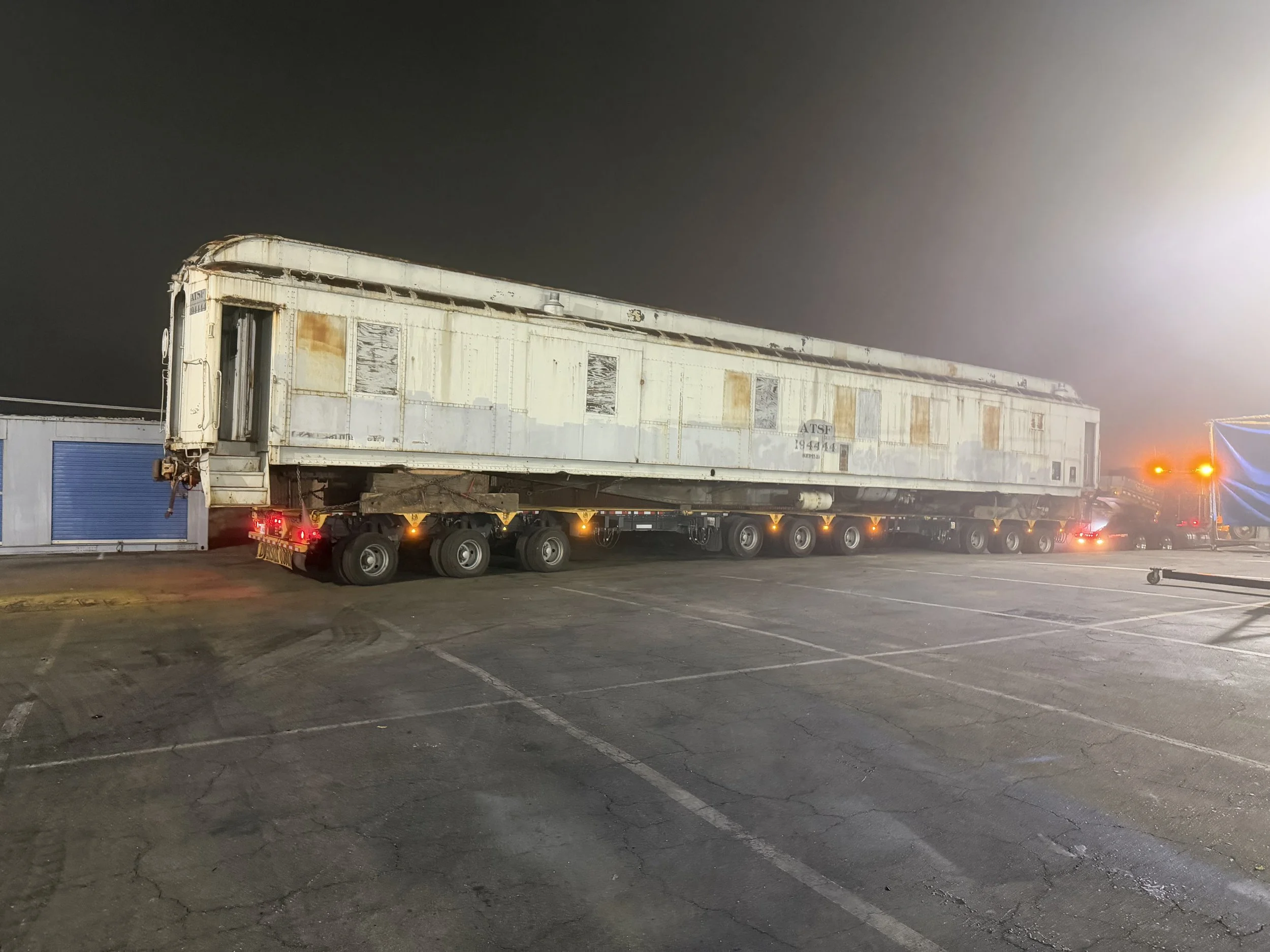ATSF Santa Fe Railway car #194444 on a heavy-haul trailer at night
