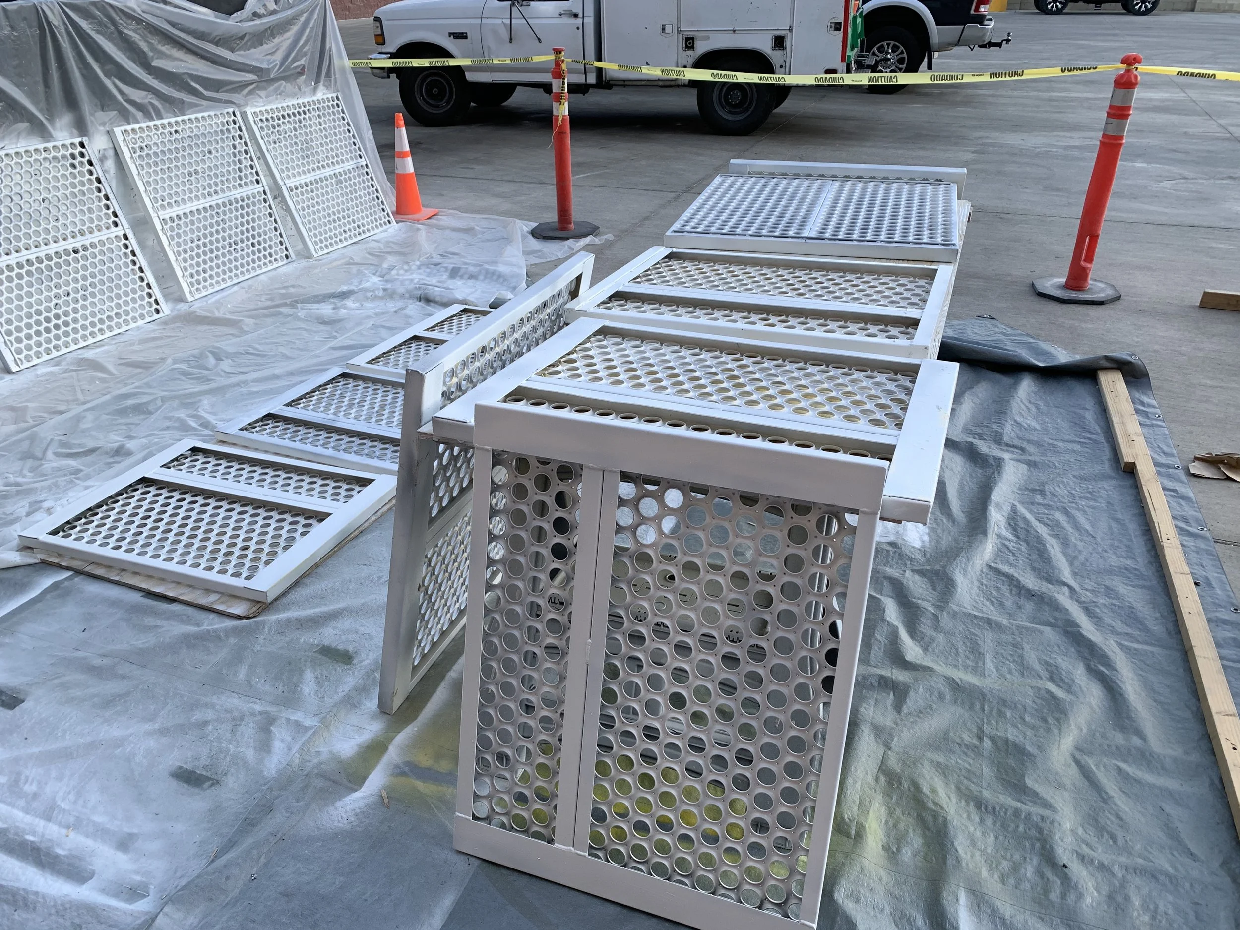 Perforated metal panels and enclosure coated white on a protected job site