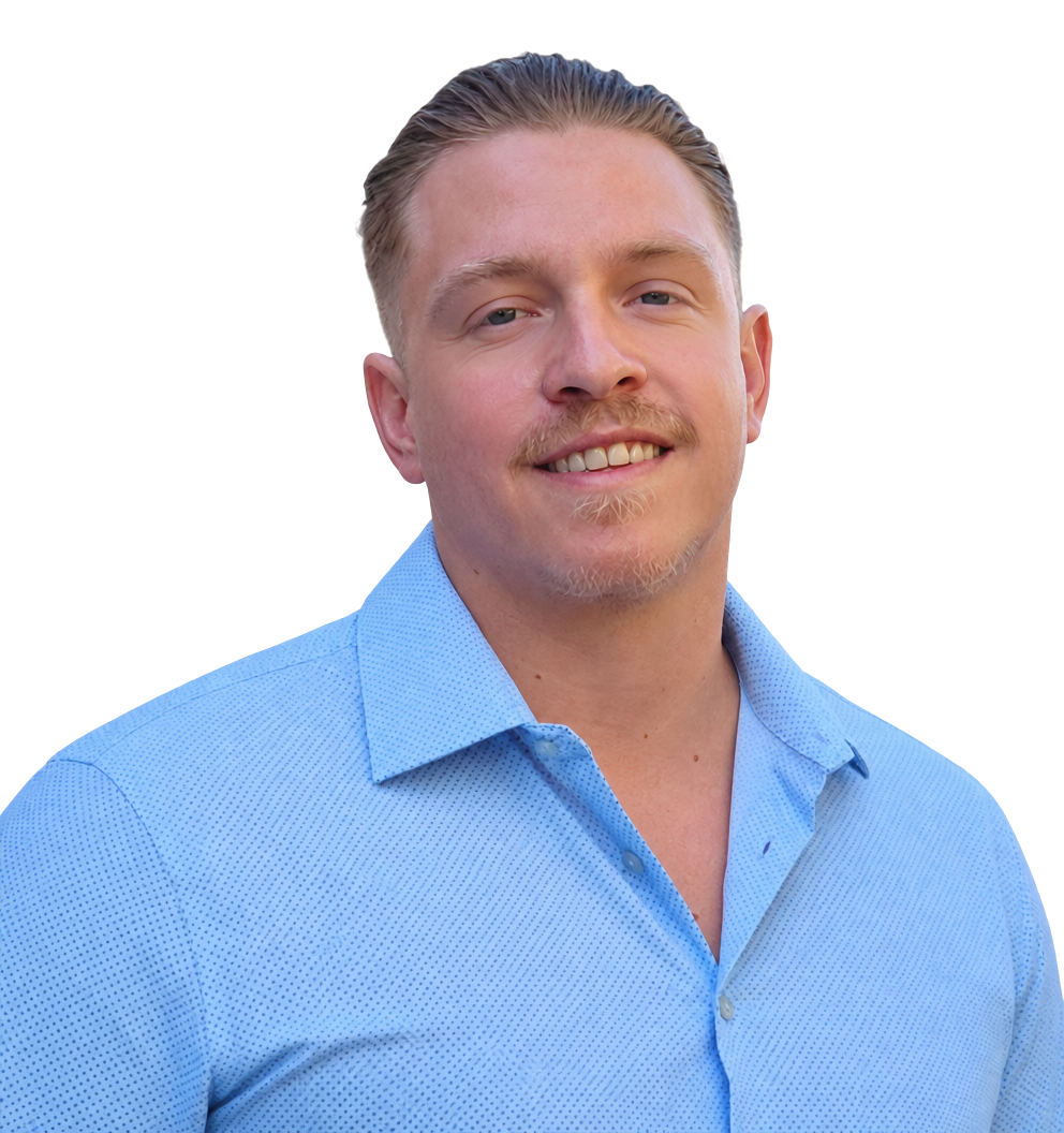 A man with blond hair, a light beard, and mustache smiling, wearing a light blue button-up shirt.