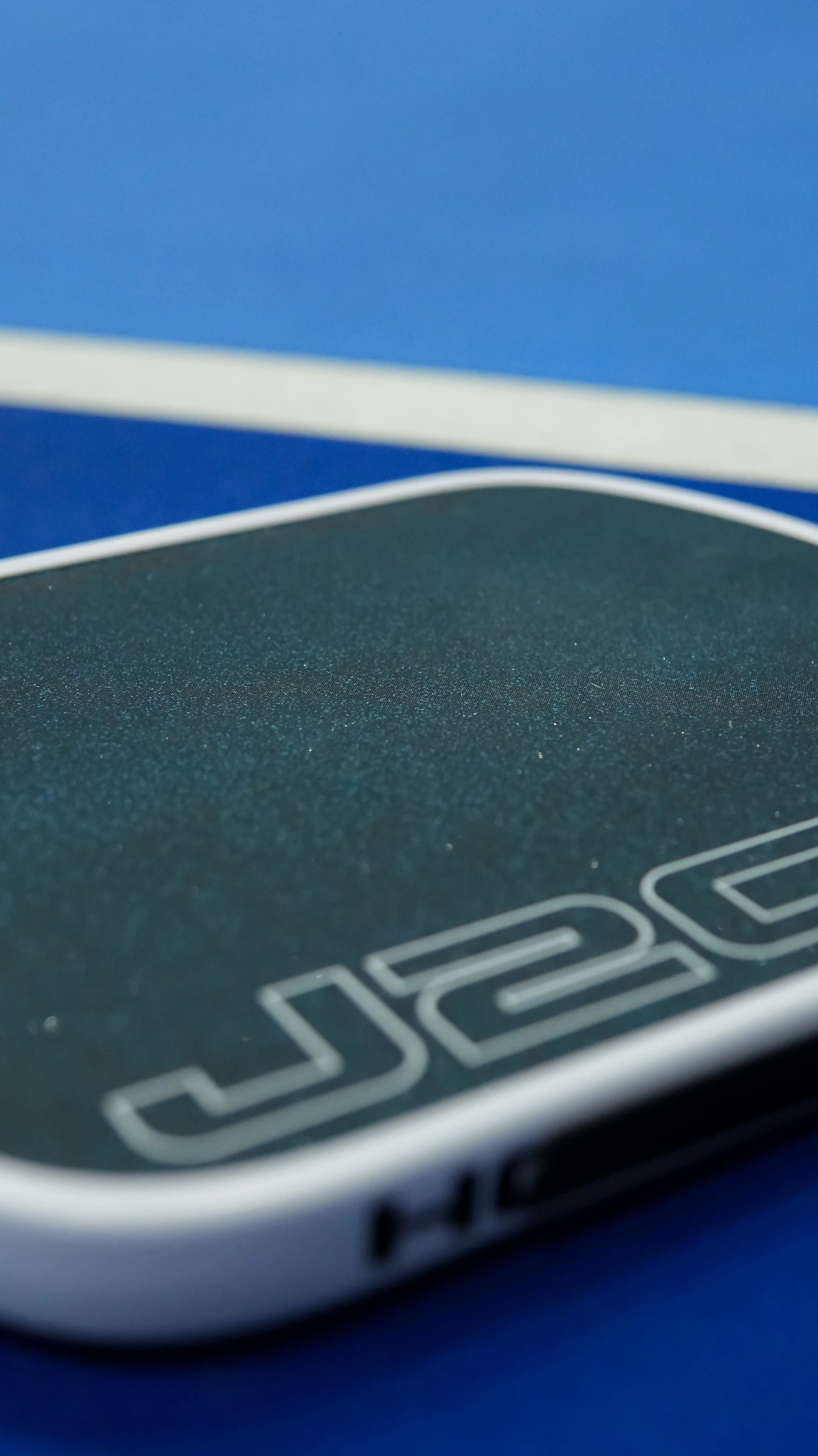 Close-up of a digital weighing scale with a textured surface and a blue background.