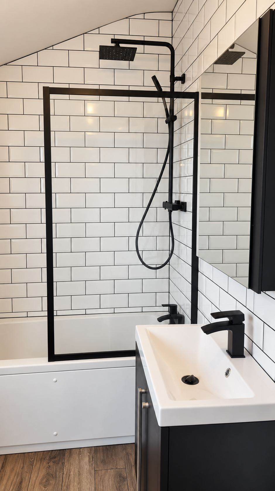 Modern bathroom with black fixtures, white subway tile walls, a glass shower screen, black rain shower heads, a white bathtub, and a white sink with black faucets.
