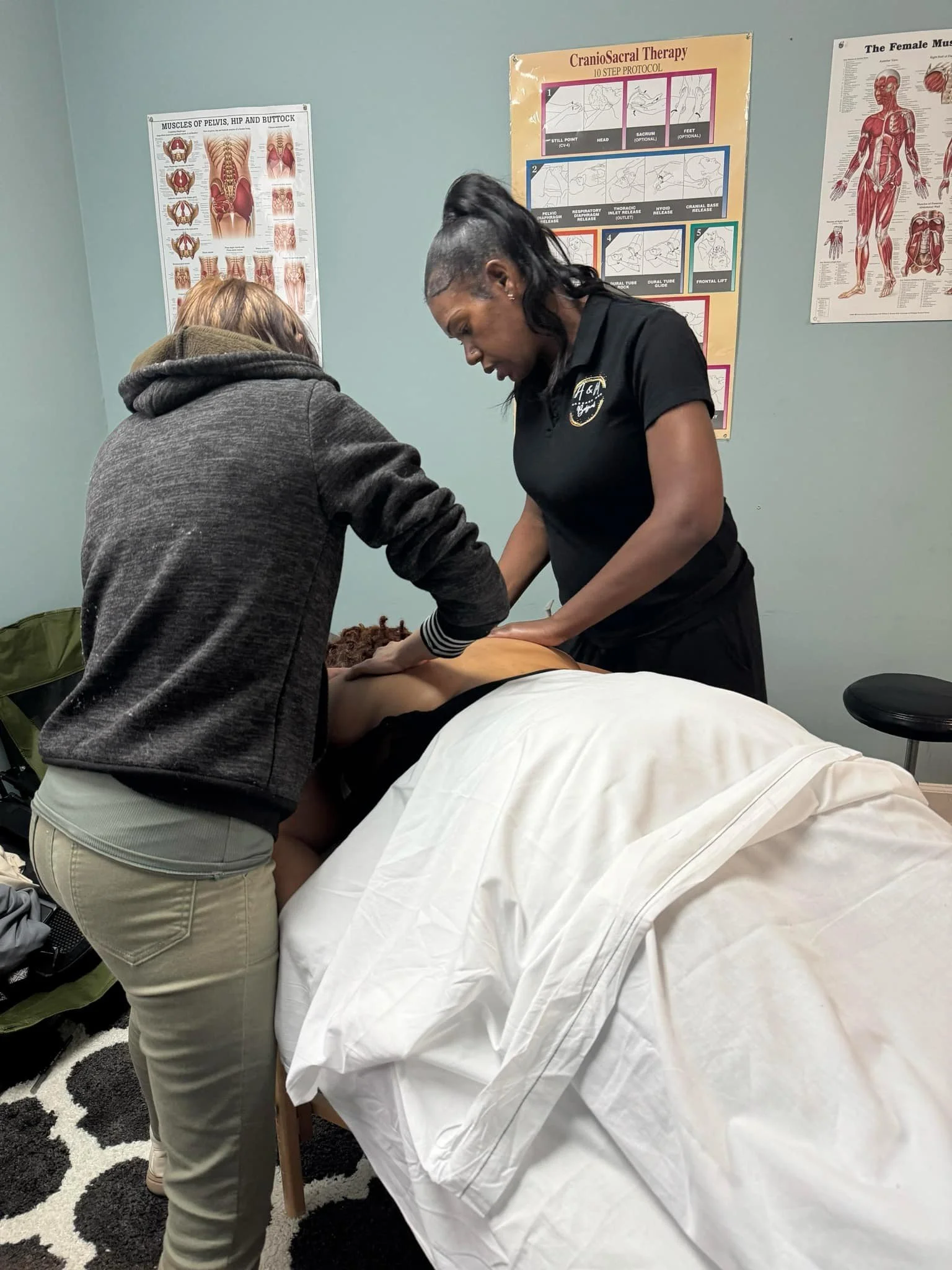 Ashley Urquhart providing one-on-one massage therapy training with a student