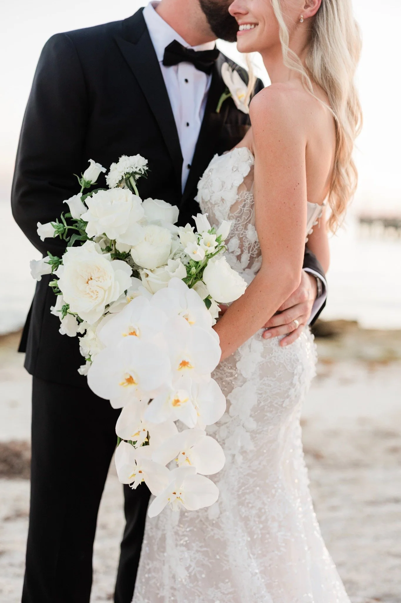 casa-marina-bride-groom-white-orchid-bouquet.jpg