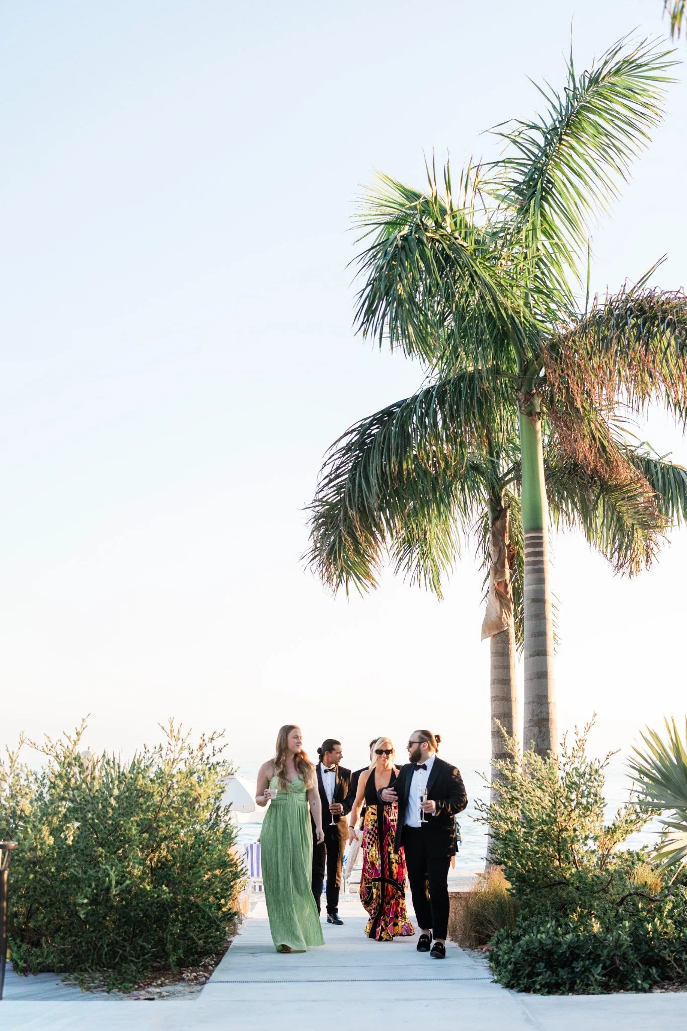 casa-marina-cocktail-hour-palm-trees-guests.jpg