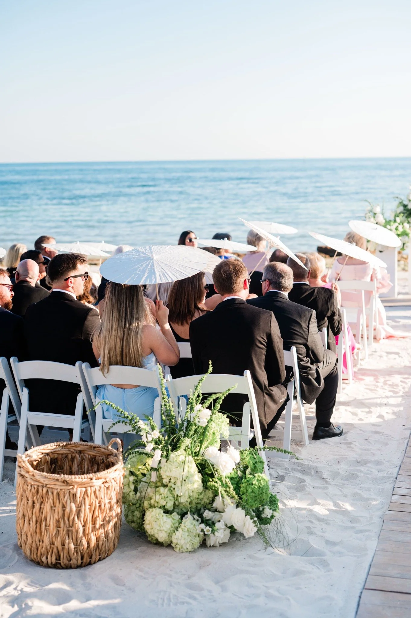 casa-marina-oceanfront-ceremony-guests-parasols.jpg