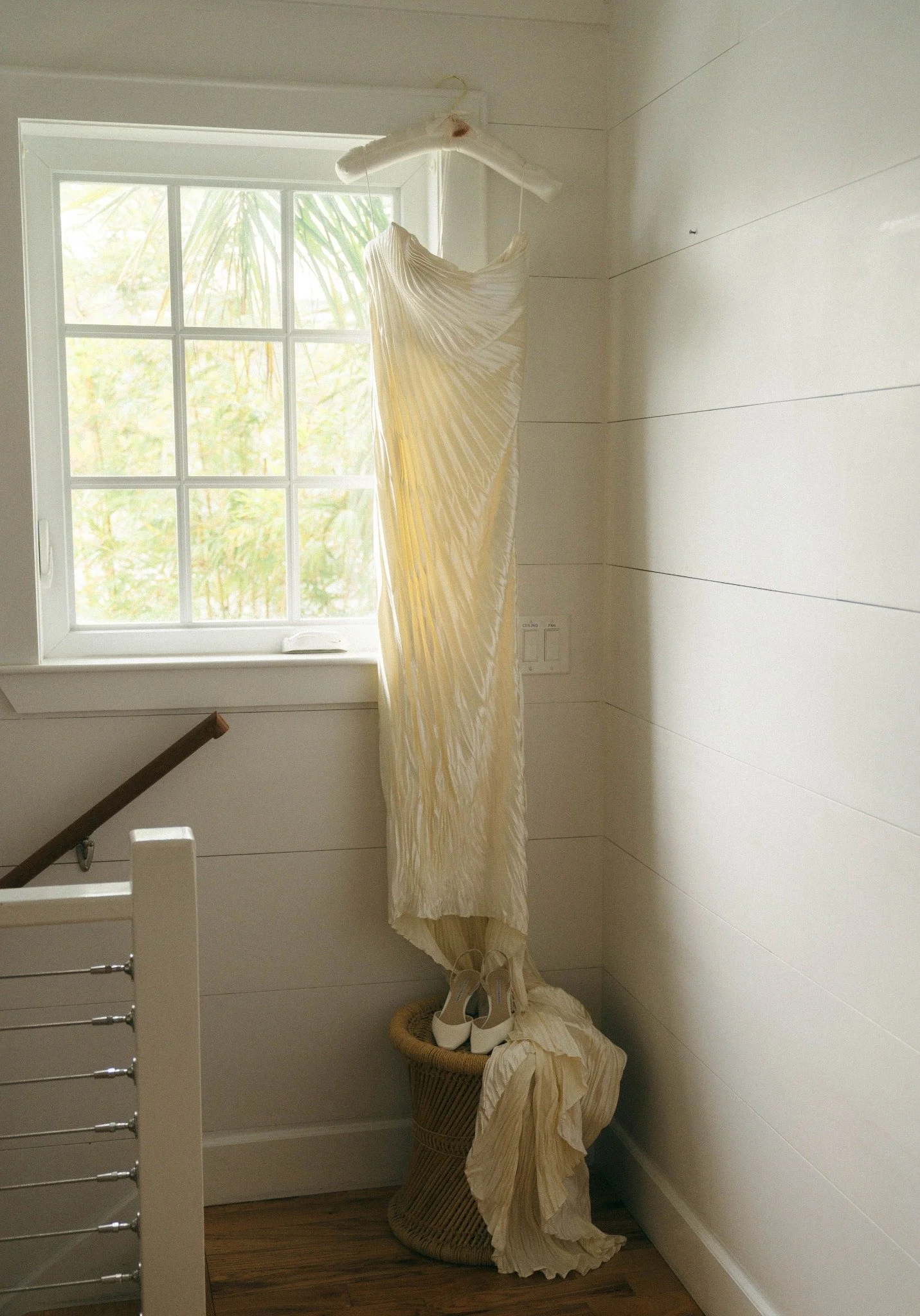 key-west-wedding-pleated-bridal-gown-hanging-window.jpg