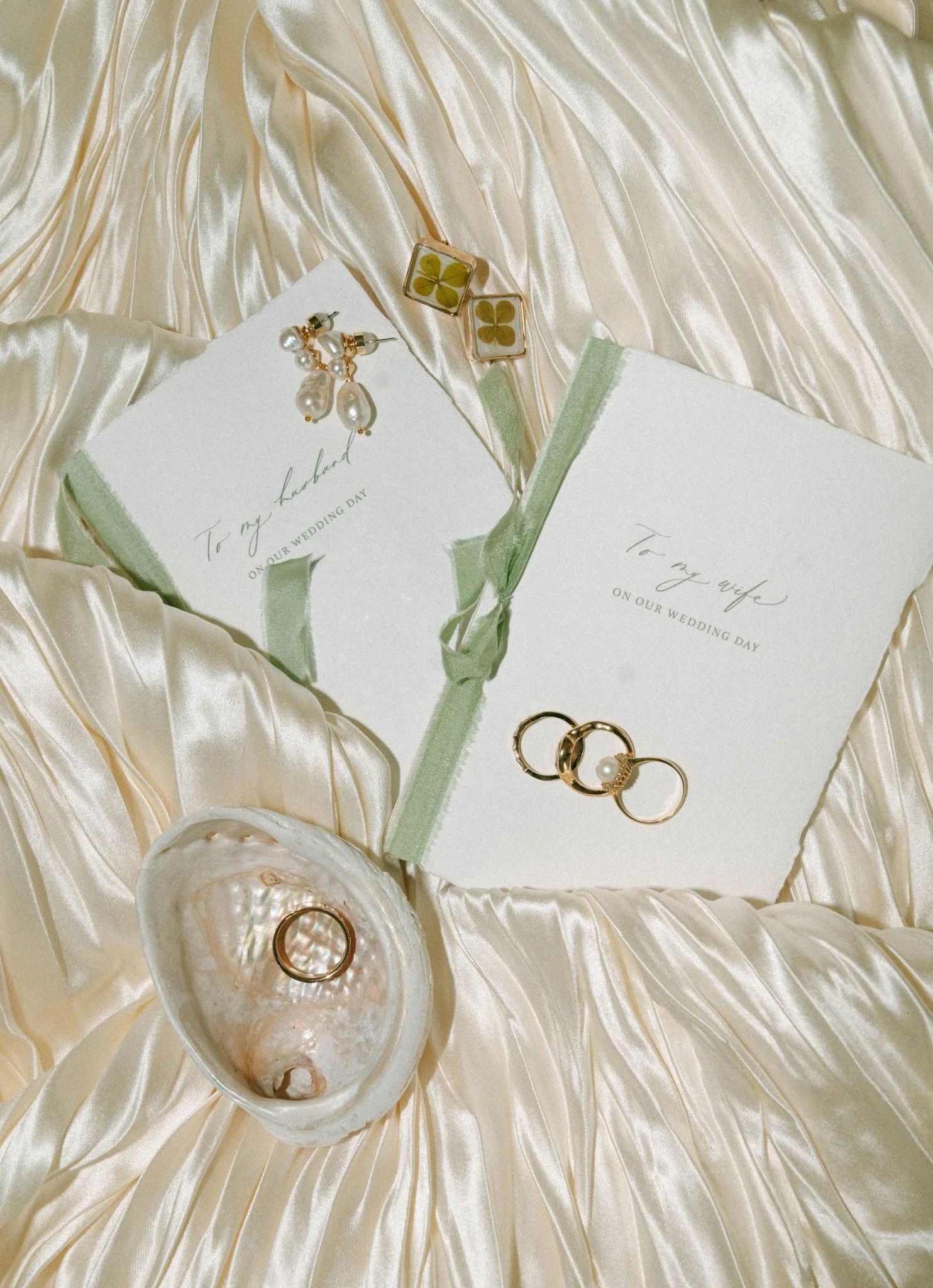 key-west-wedding-vow-books-rings-pearl-earrings-flatlay.jpg