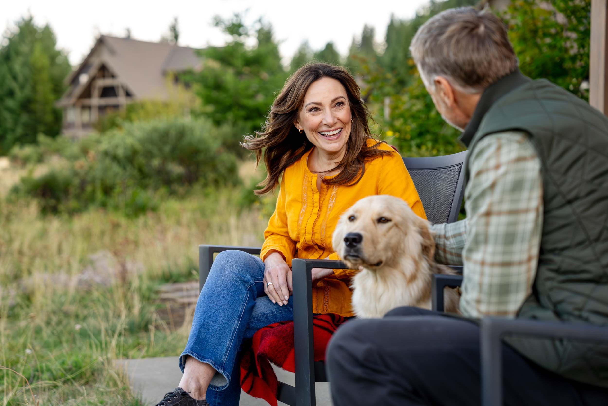Woman-Smiling-at-Man-and-Dog-Outside-Inti_St_Clair_Austin_Texas_20240917_Tumble Creek_Scene 16_Lower Deck_3996.jpg