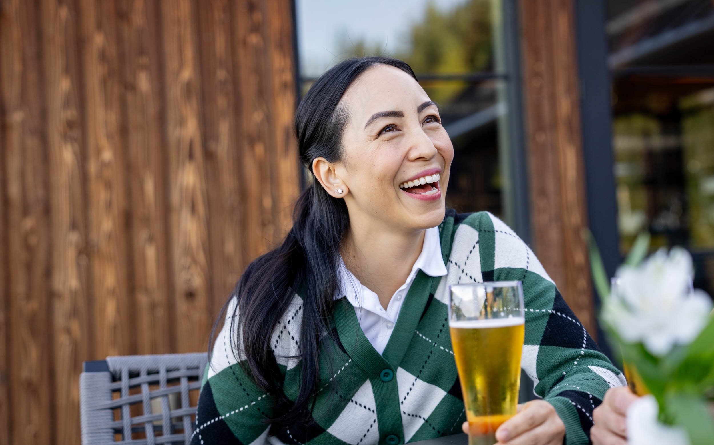Woman-Enjoying-Beer-Outdoors-Inti_St_Clair_Austin_Texas_20240917_Tumble Creek_Scene 26_Beers on Deck_7826.jpg