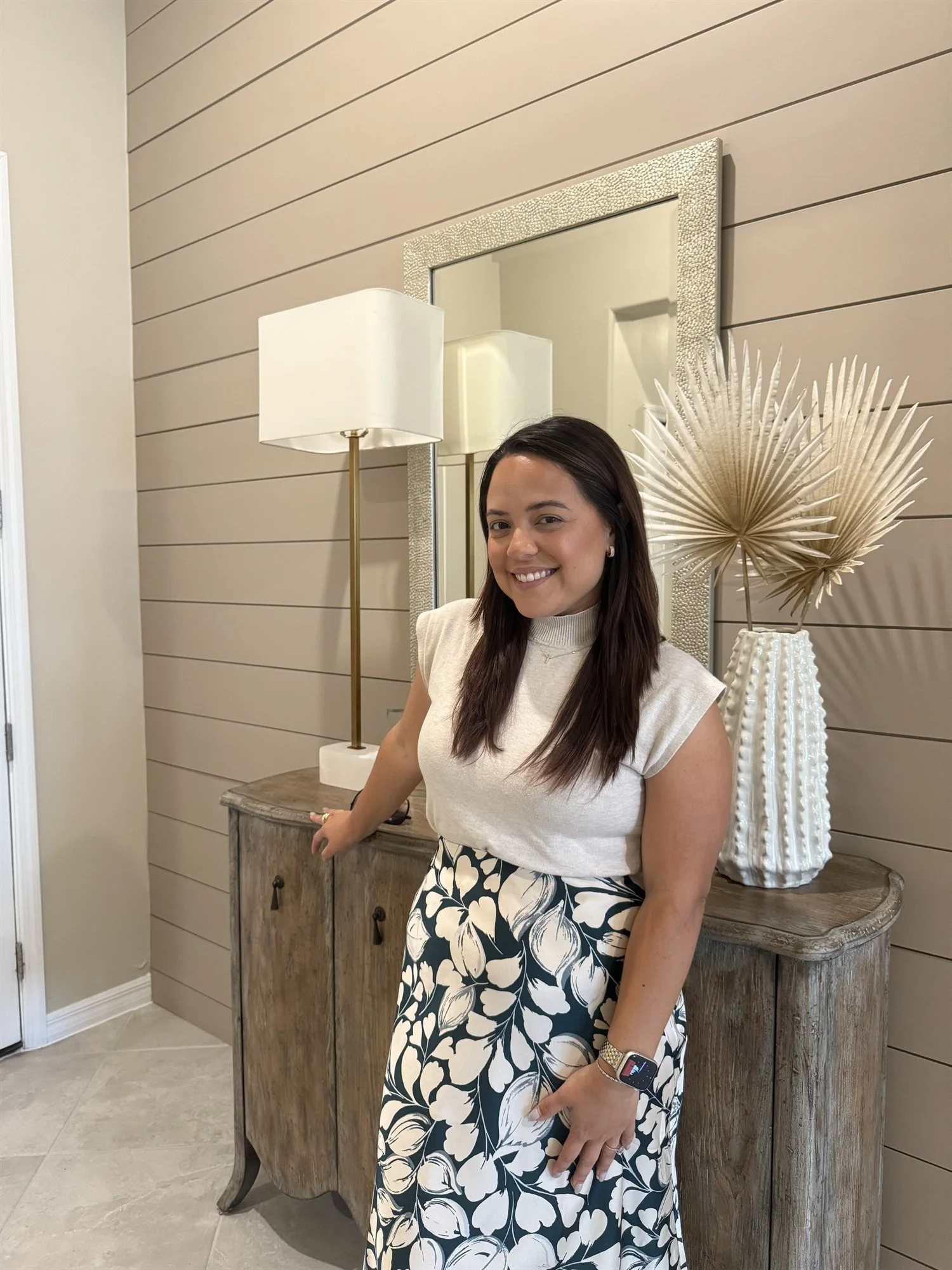 Andrea Cerrada, bilingual Naples FL REALTOR with LUXE Properties, smiling in a new construction model home
