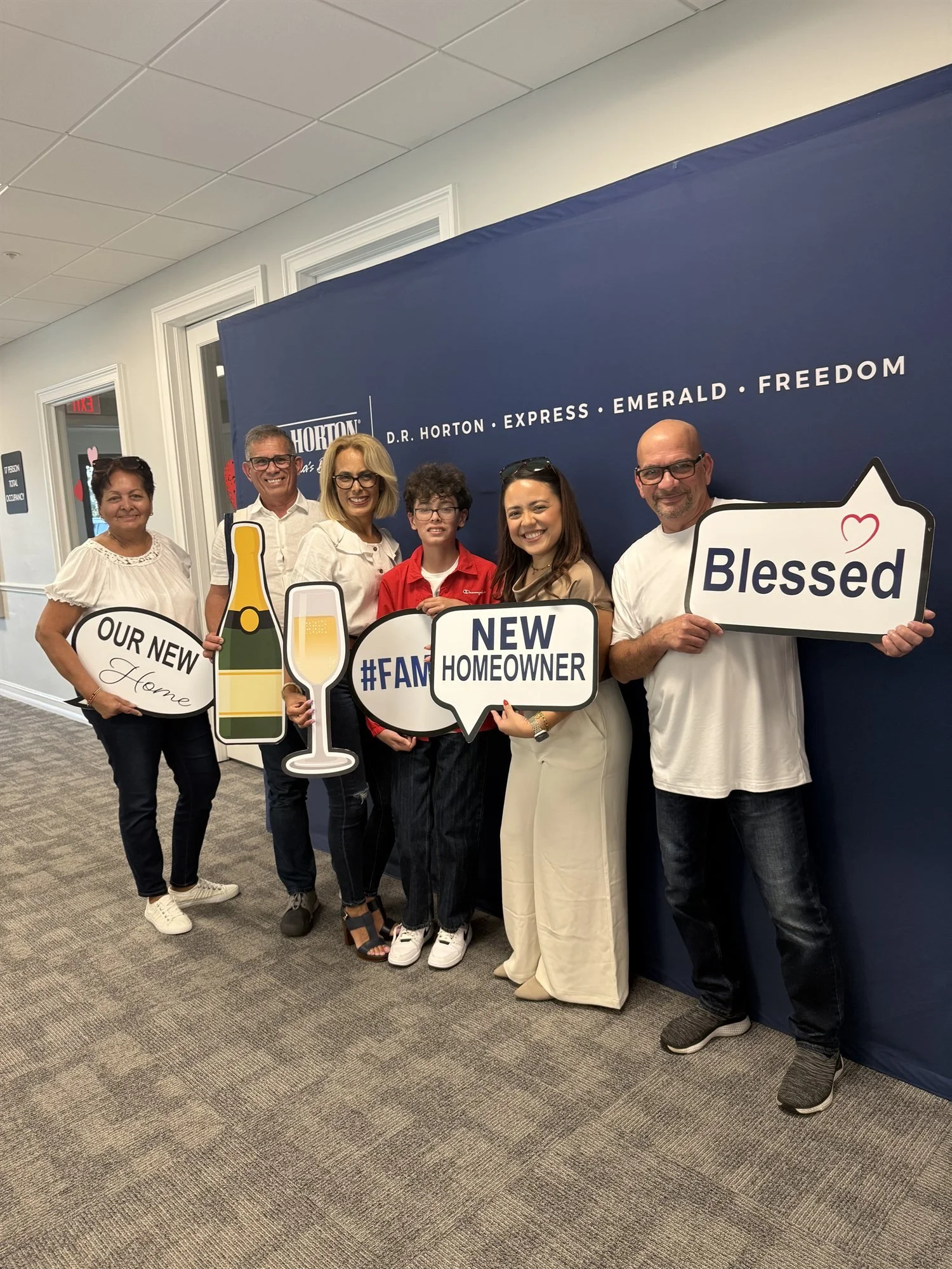 Andrea Cerrada with new homeowners celebrating a D.R. Horton new construction closing