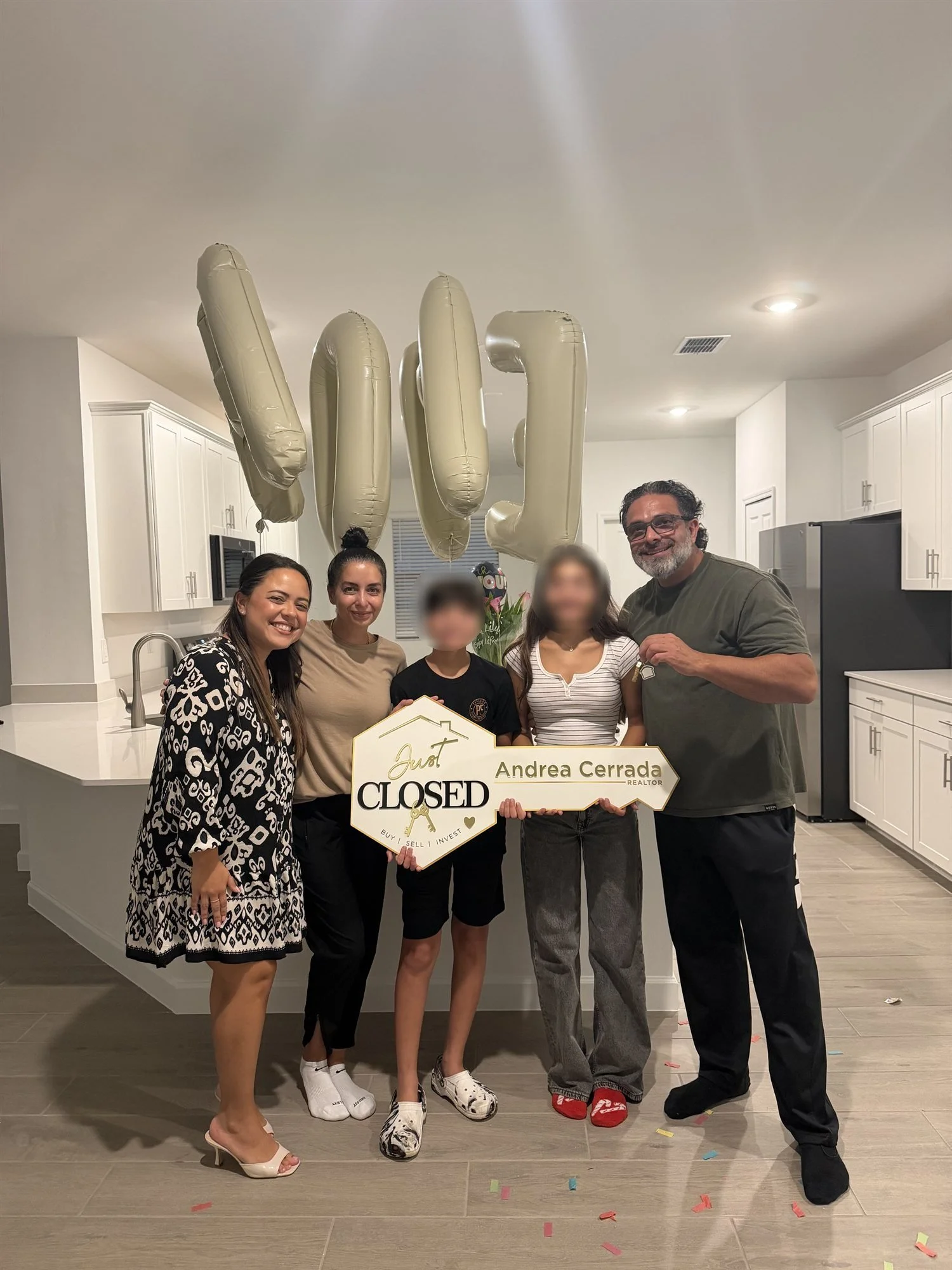 Andrea Cerrada with a Naples family celebrating their new home with balloons