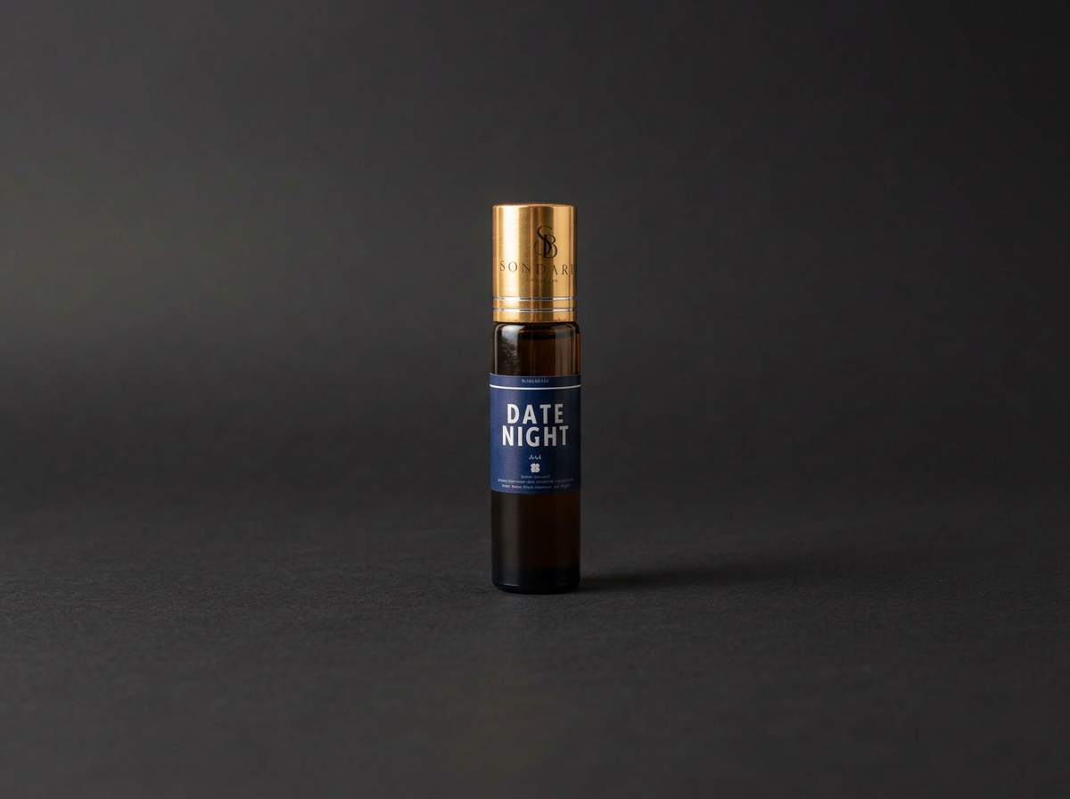A small dark brown roll on bottle with a gold cap and blue label reading 'Date Night' is centered on a dark gray background.