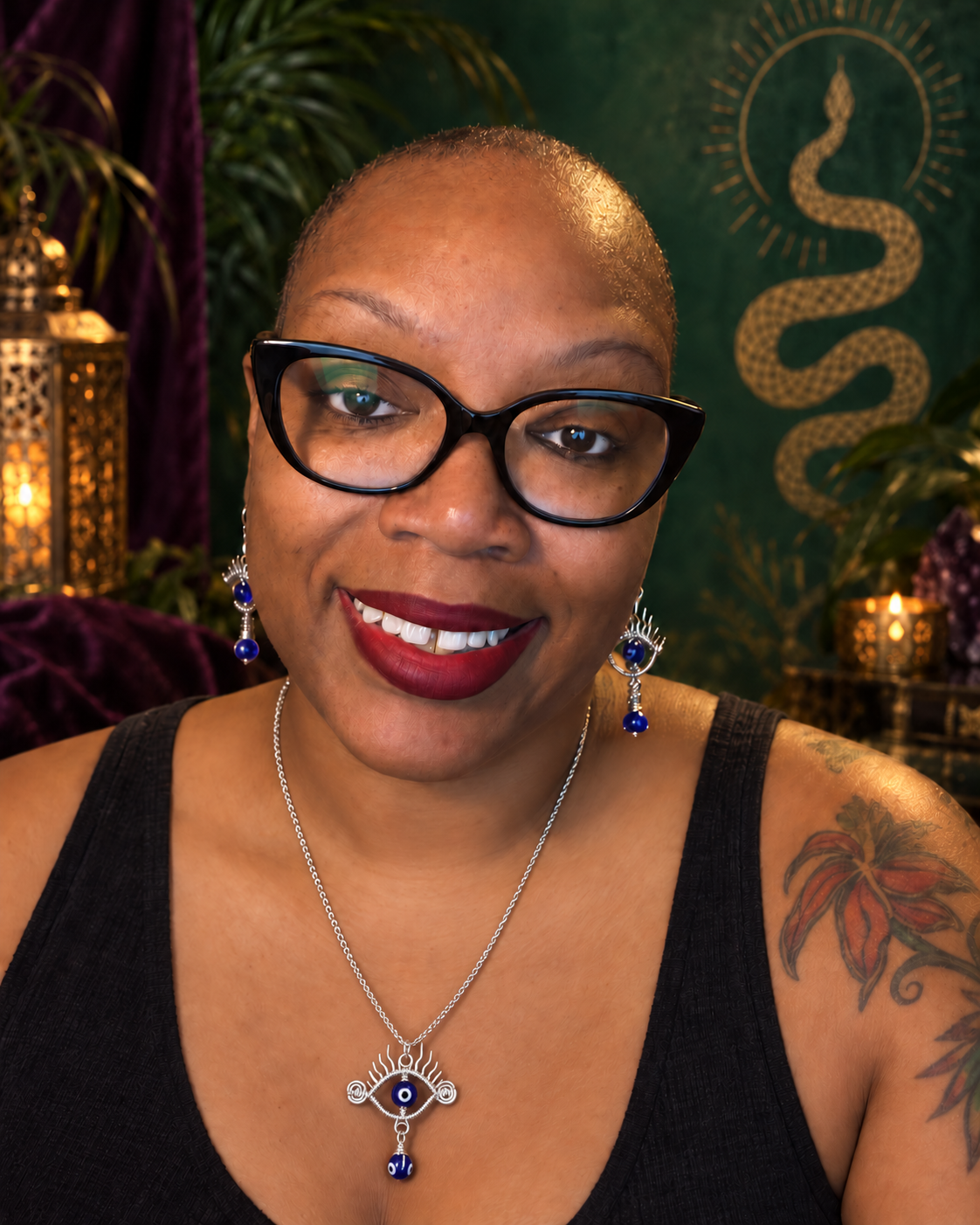 Nicole Renee smiling in an emerald and gold Sacred Serpent-inspired bohemian setting.