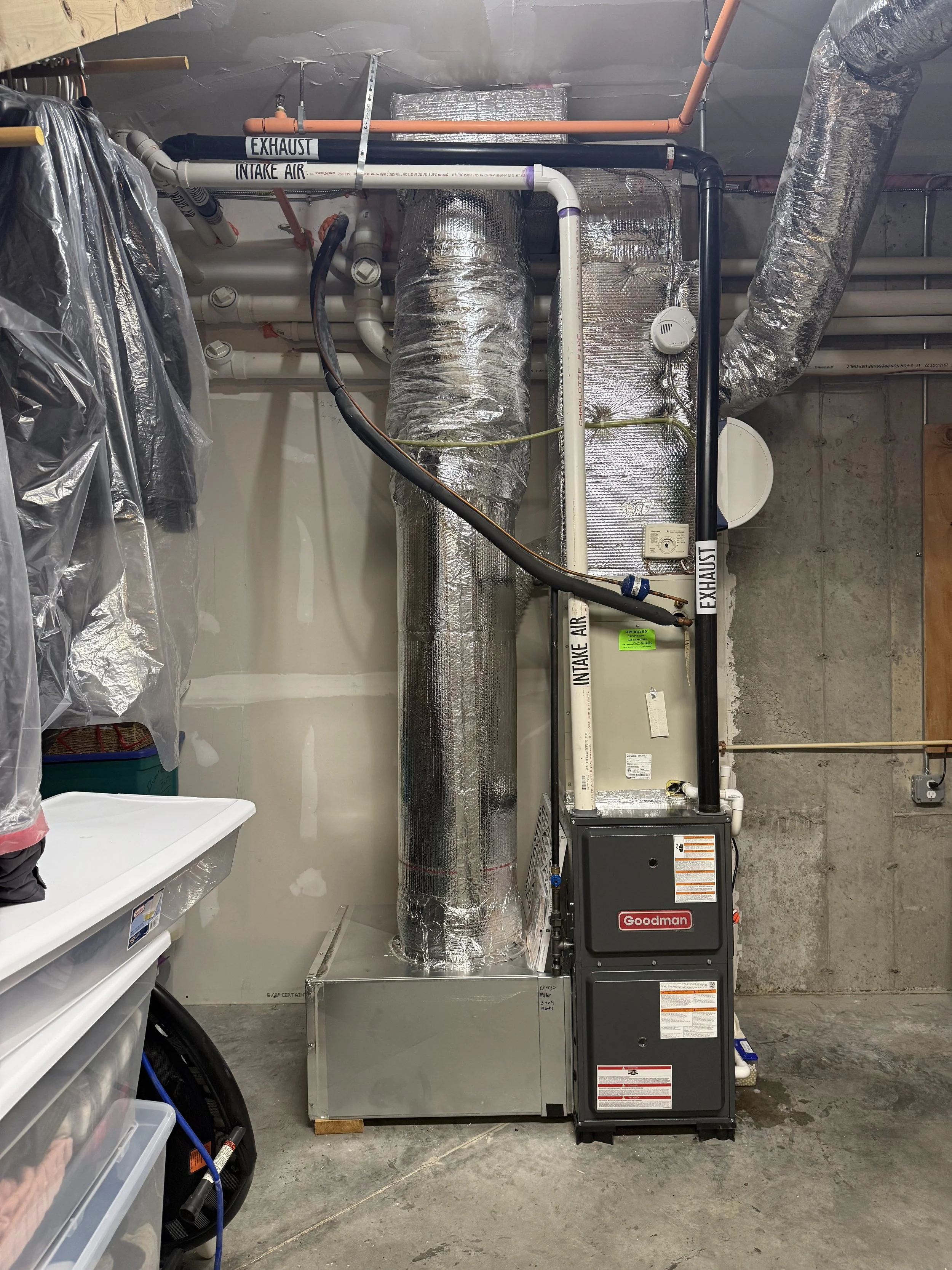 Ceiling with HVAC ductwork, pipes, and insulation in a basement or utility room.