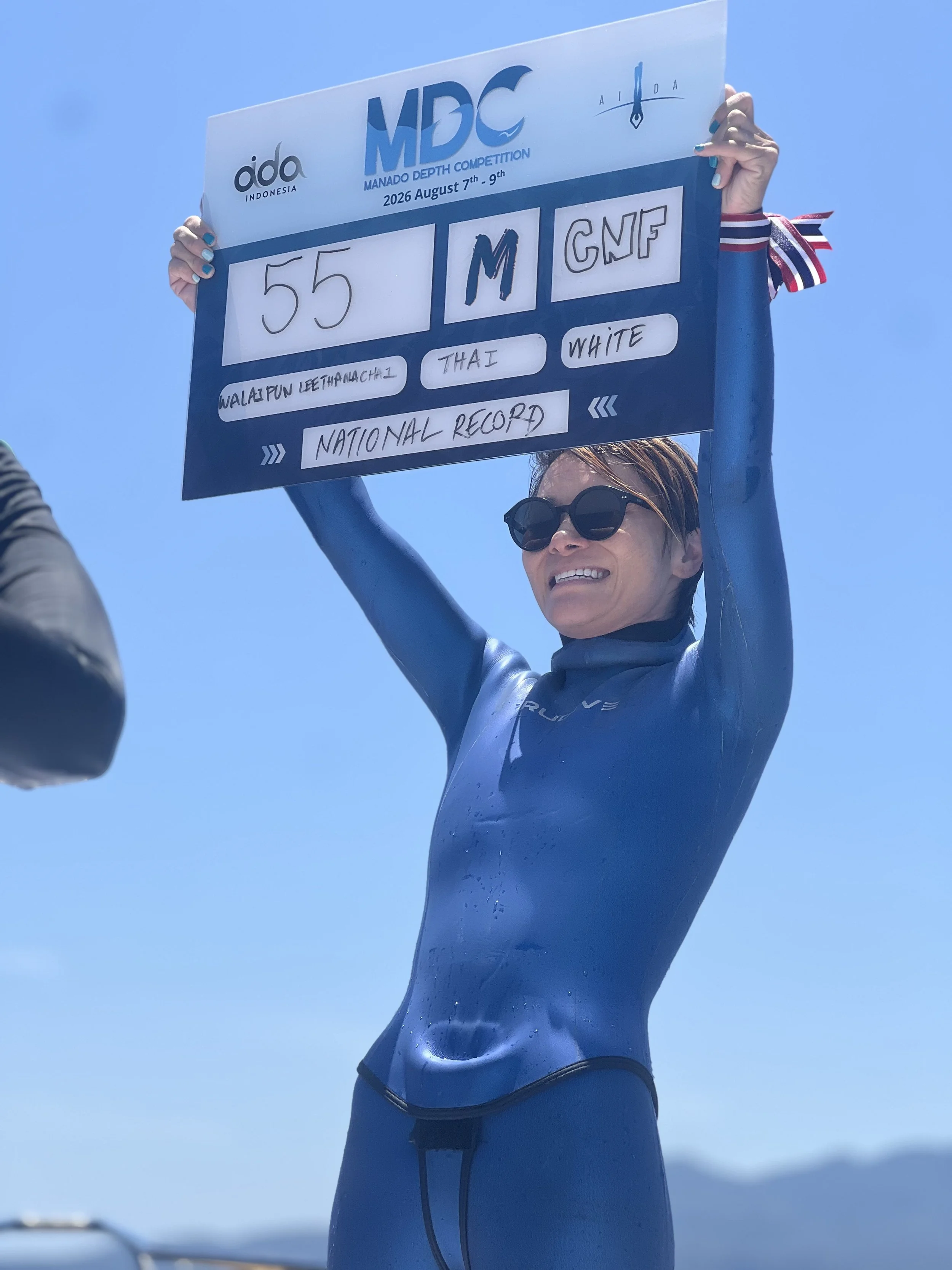 Competitive freediver holding a 55 metre CNF or No Fin Disciplinecompetition performance board