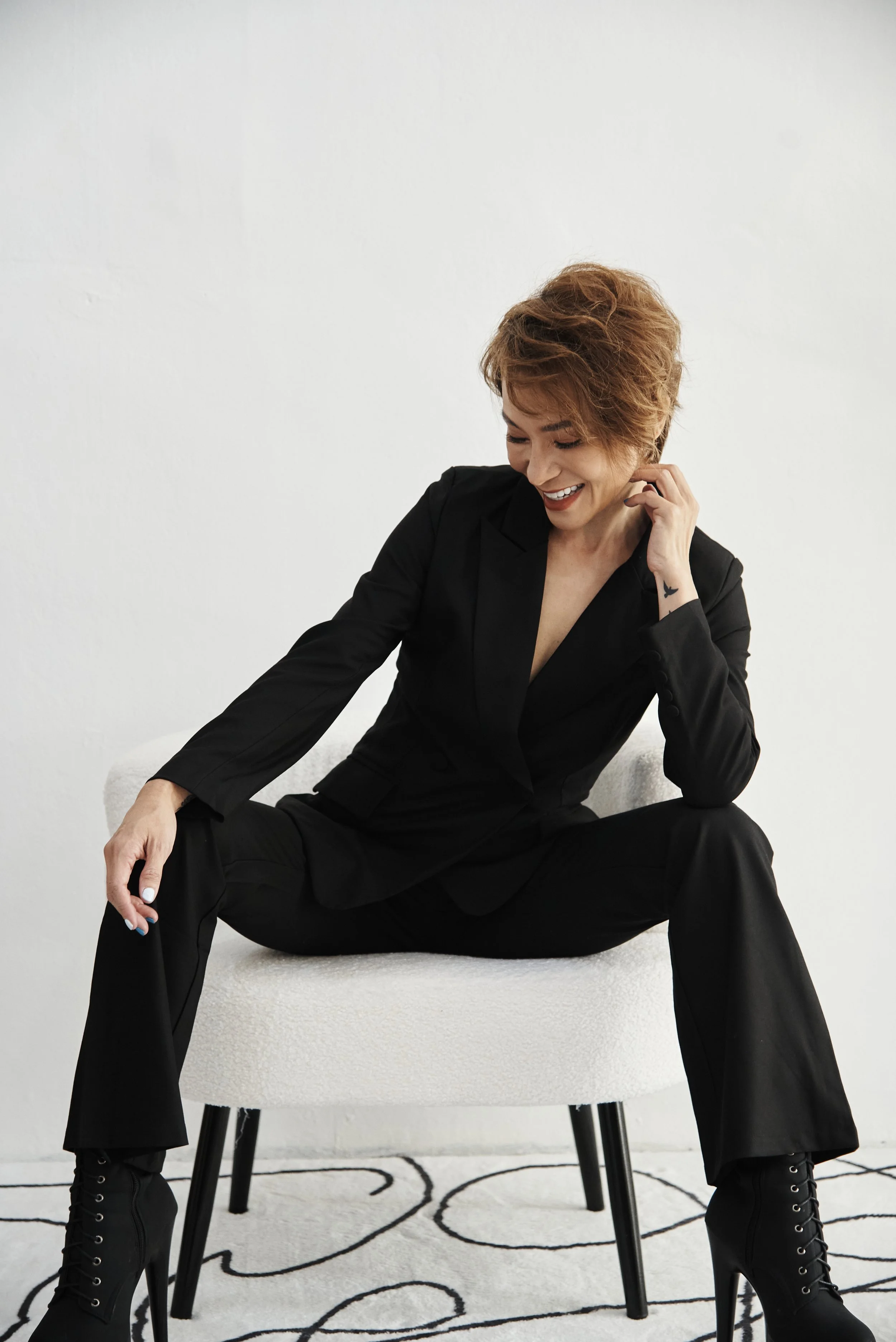 Founder of Odytide seated in a black suit, offering life design and personal coaching