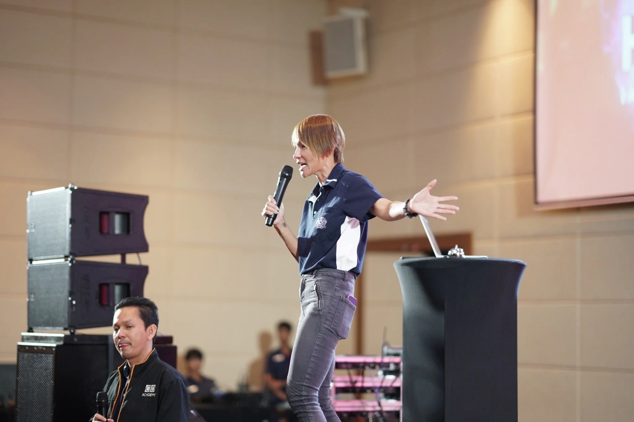 Odytide coach speaking on stage at a professional event