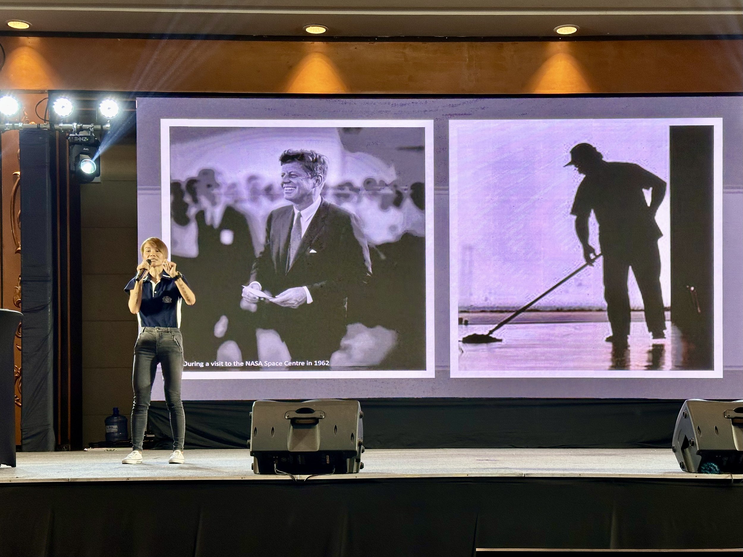 Odytide founder presenting a workshop on stage in front of projected presentation slides