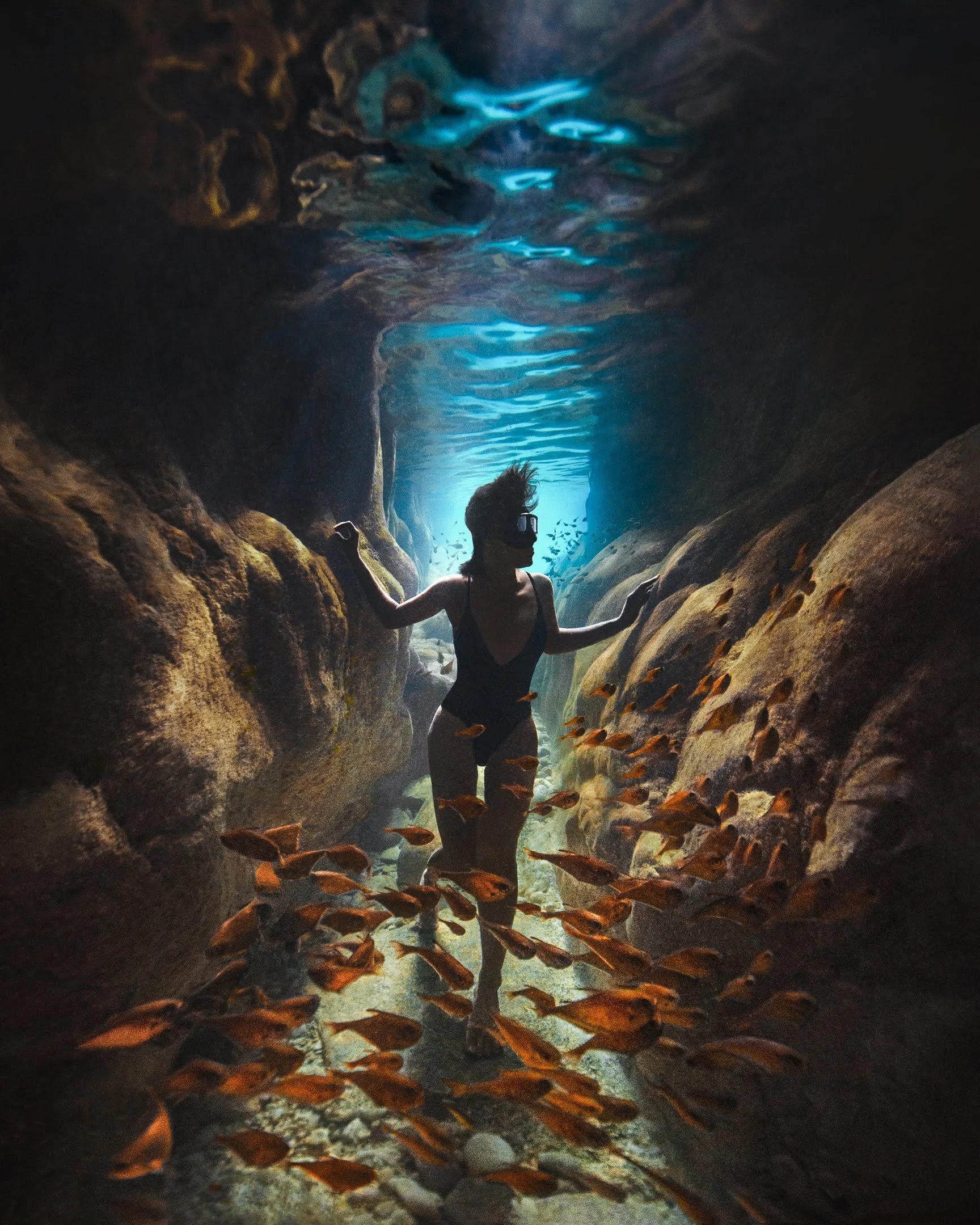 Walaipun working as an underwater model and freediver surrounded by fish in clear water