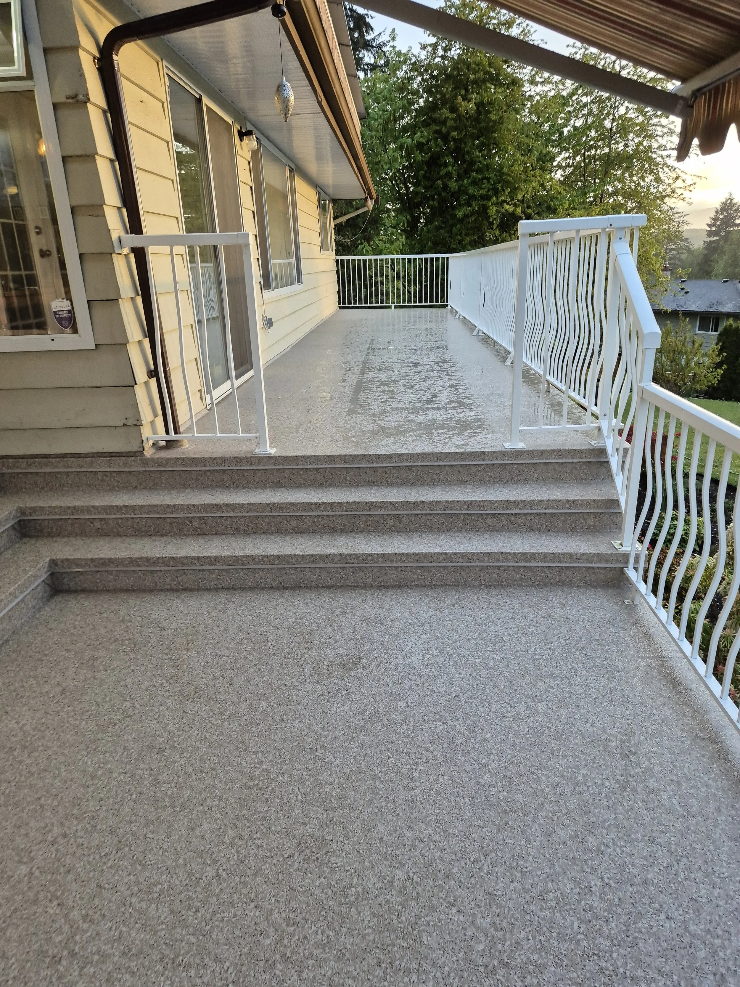 Waterproof vinyl deck installation with aluminum railing on Vancouver Island