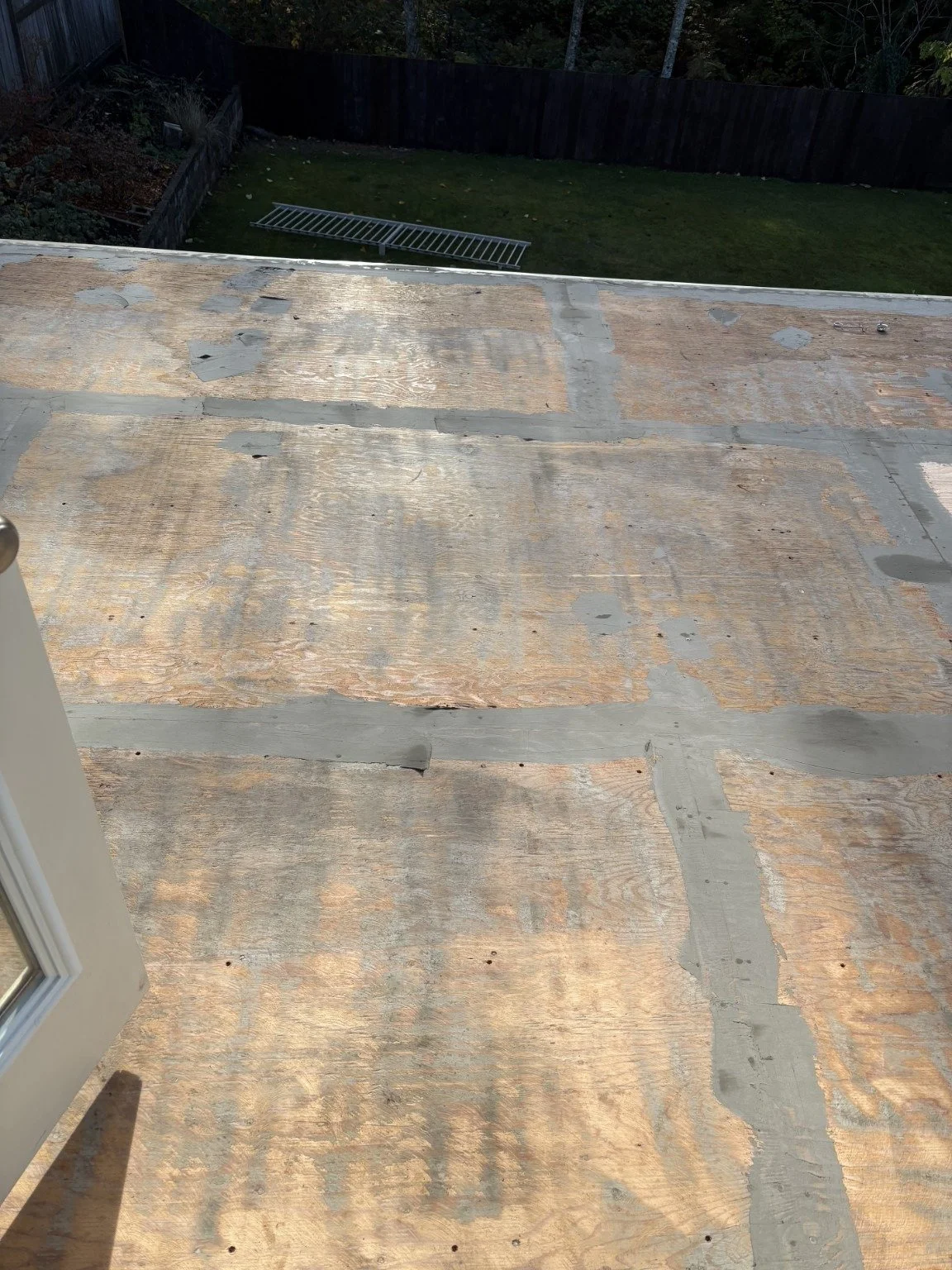 Preparation: plywood deck surface with seams filled before vinyl installation.