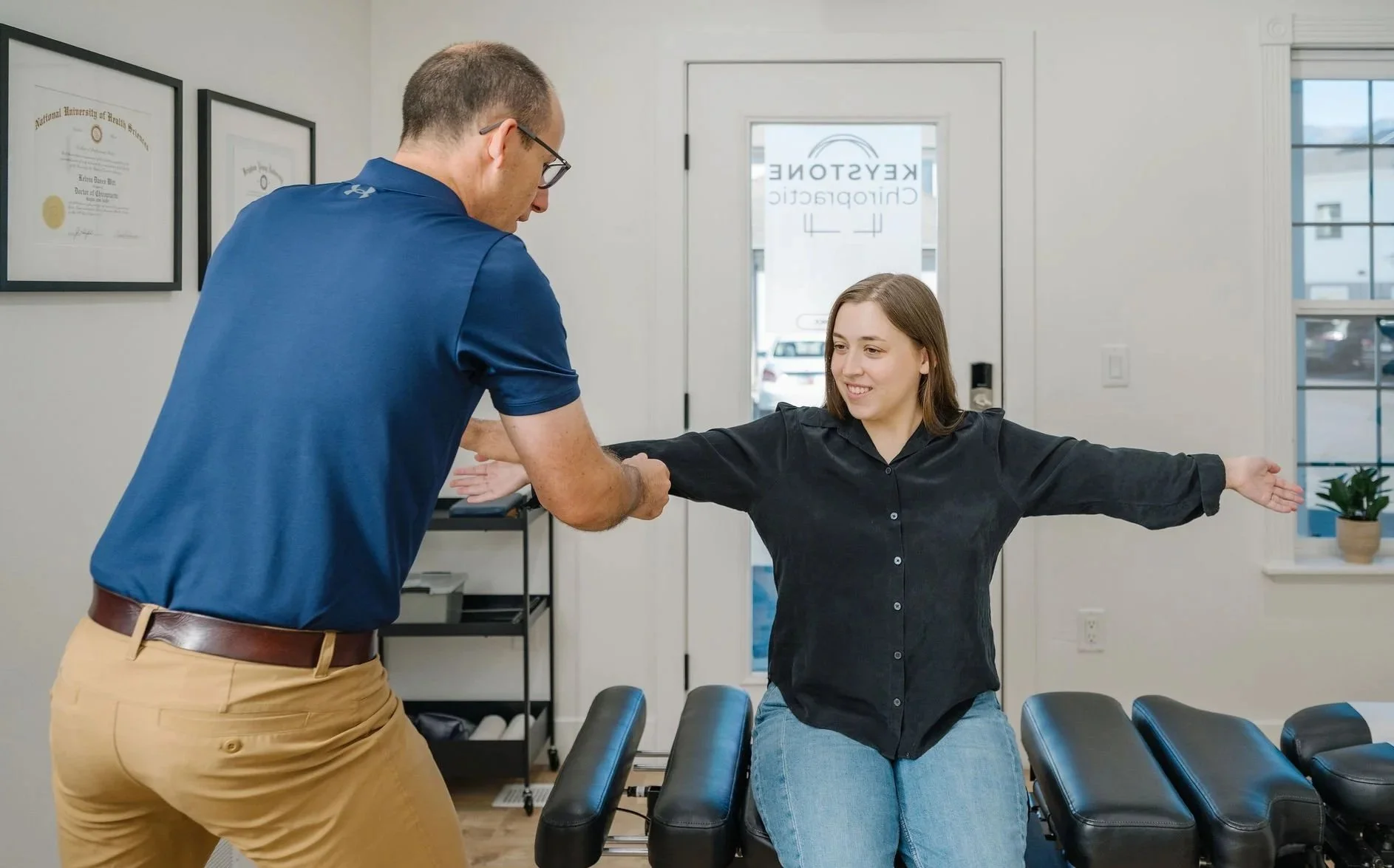 Dave Witt, D.C., conducting an initial chiropractic exam and patient consultation at Keystone Chiropractic.