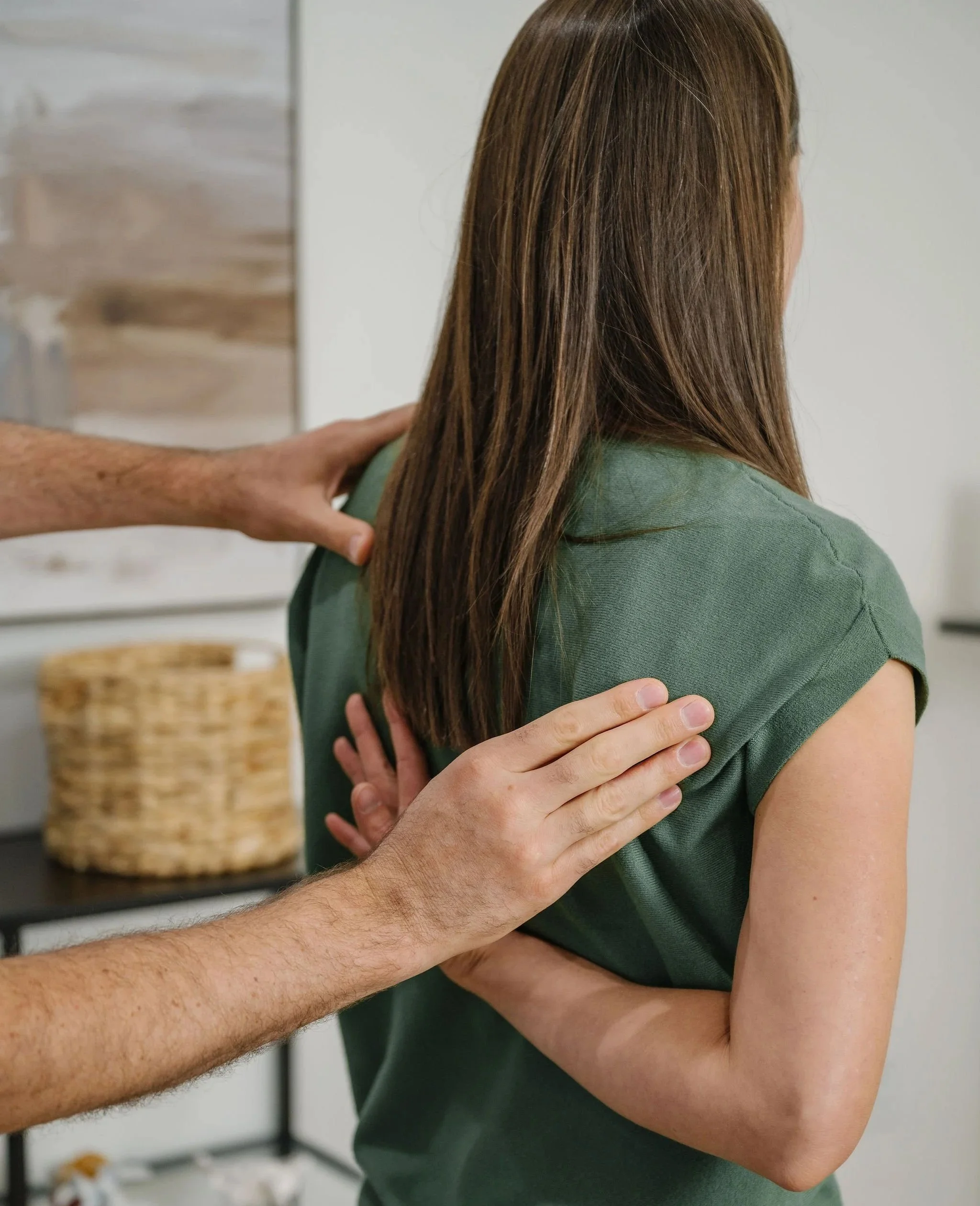 Dr. Dave Witt examining a patient's shoulder mobility during an intake examination at Keystone Chiropractic.