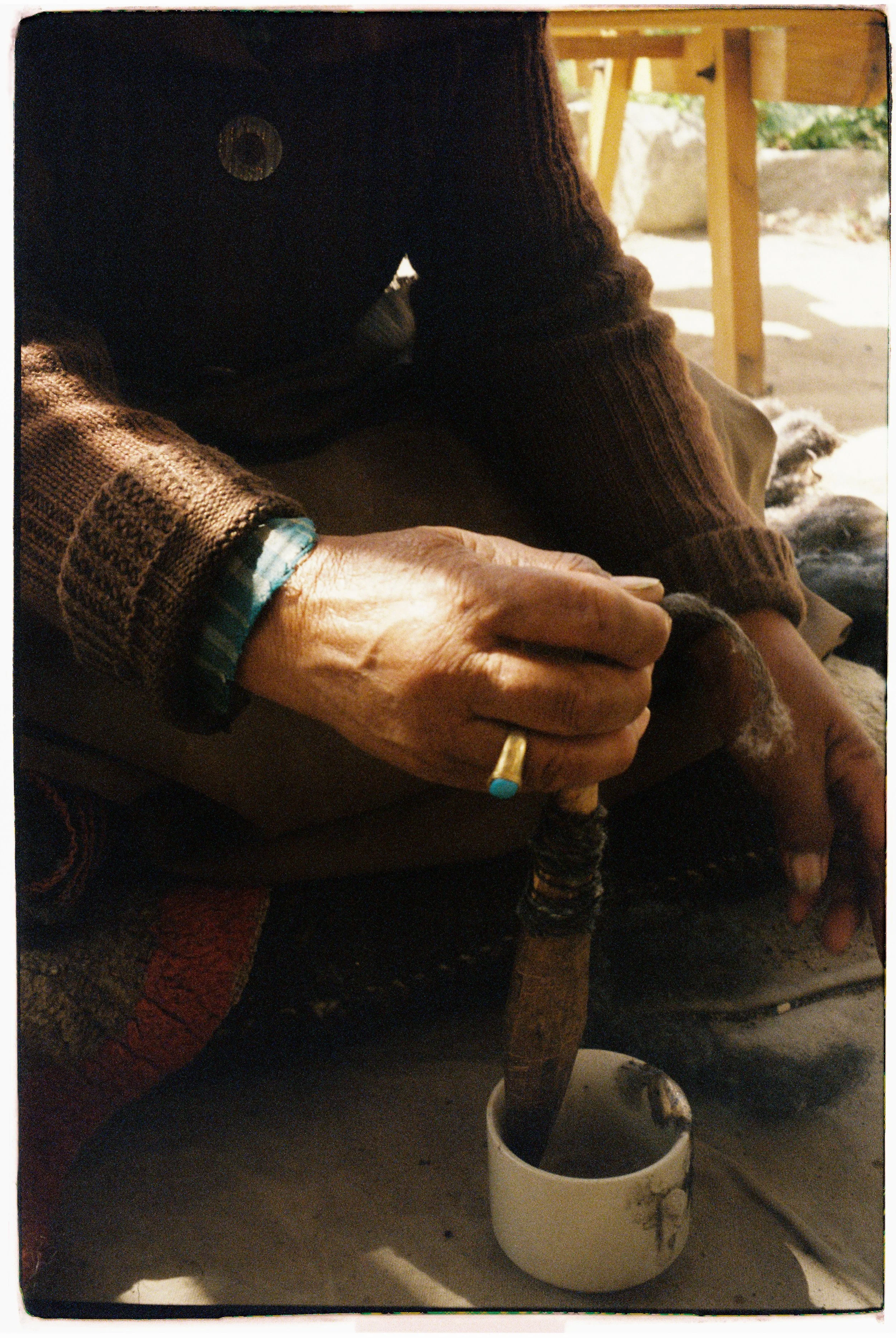 Ladakhi woman using a spindle to create wool thread. Film photo taken in Leh, Ladakh by Olivia Ladesic.