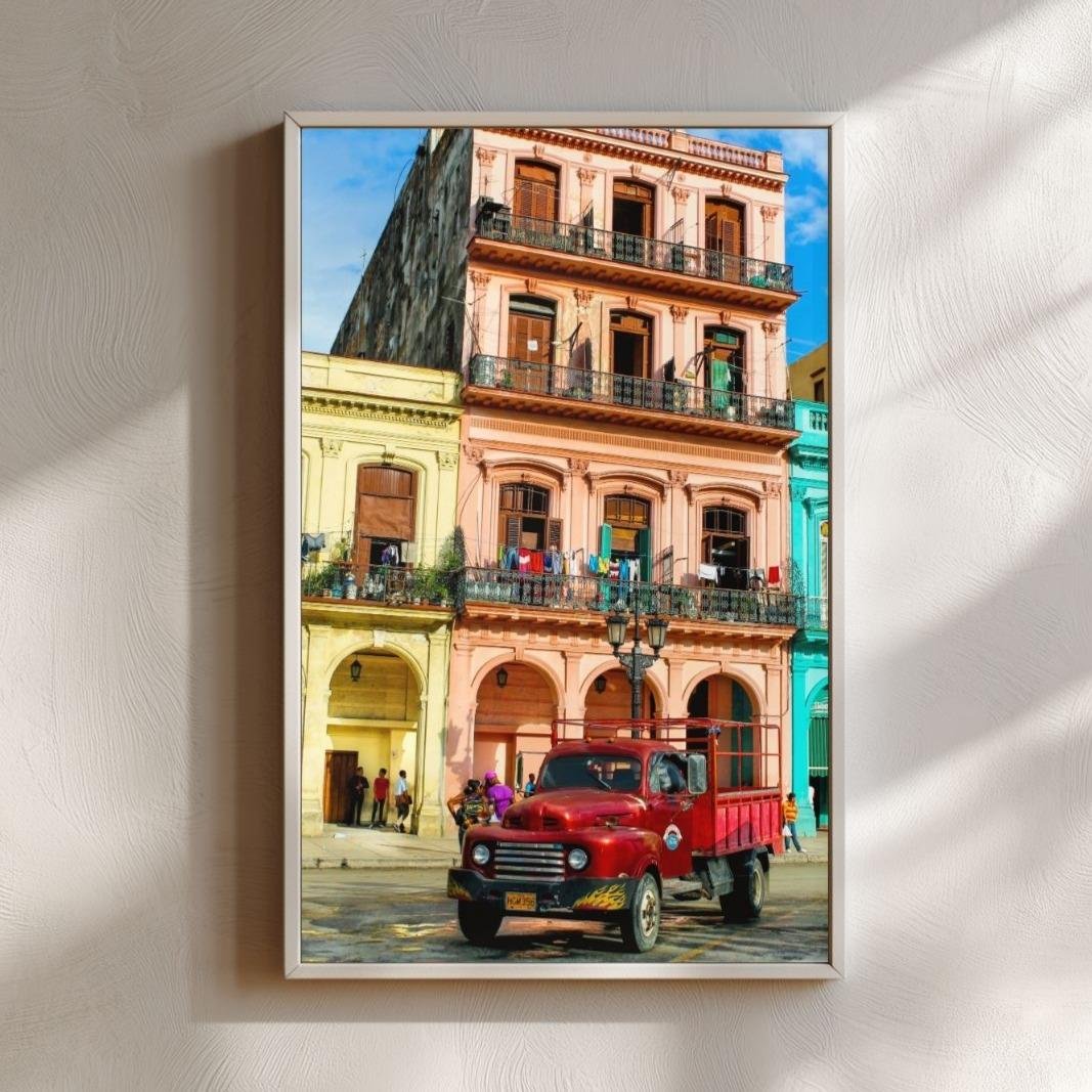 Mockup of framed print showing 1950s red Ford truck parked in front of sherbet-colored buildings in Havana, Cuba.