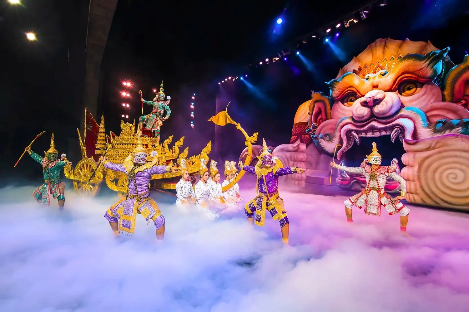 Masked dancers and golden chariot on stage at the Phuket FantaSea show