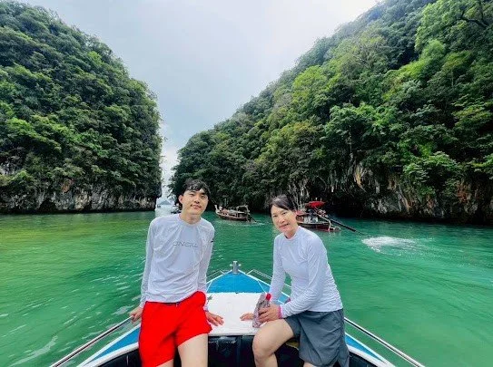 hong-island-guests-on-boat-bow-in-emerald-lagoon.jpg