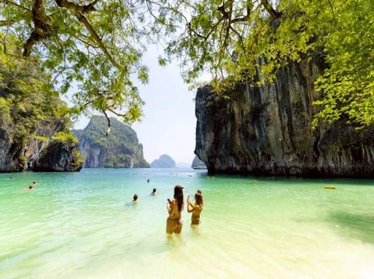 hong-island-swimmers-in-turquoise-lagoon-with-limestone-cliffs.jpg