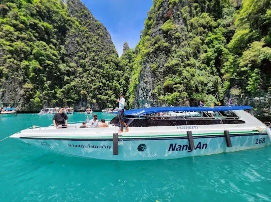 krabi-speedboat-in-turquoise-bay-limestone-cliffs.jpg