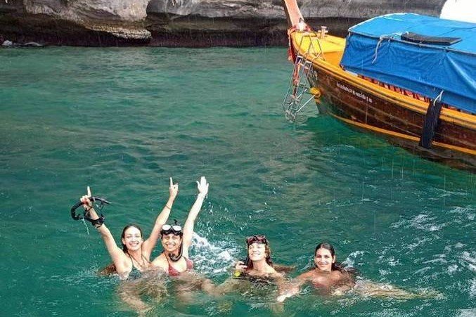krabi-guests-swimming-near-longtail-boat-landscape-crop 2.jpg