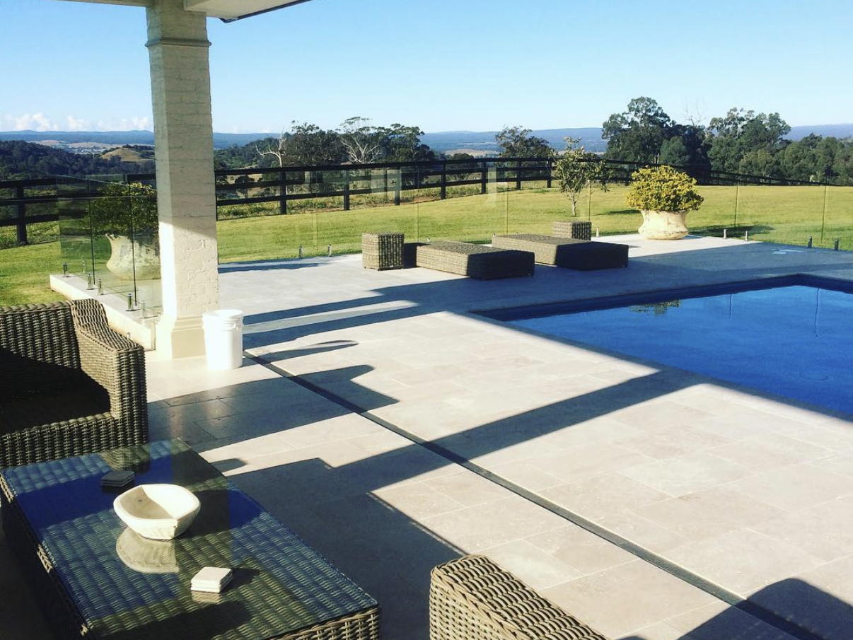 Acreage views of Razorback Camden. Outdoor pool fence cleaned to perfection. Life style at its best. Resort style home looking over the valley below with rolling hills and countryside on a clear blue sky day.