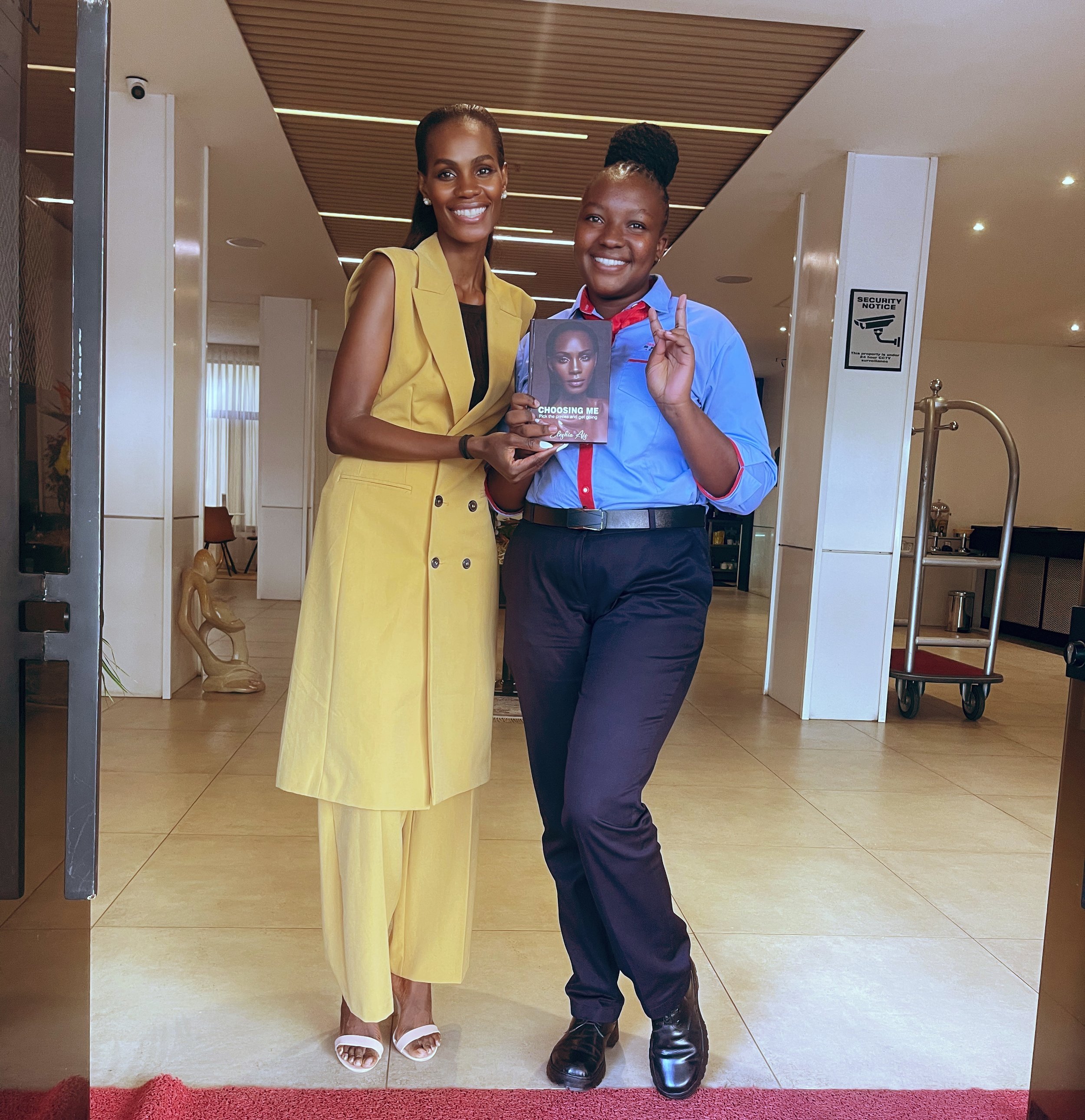 Eleshia Ais giving "Choosing Me" signed copy during her visit in Kisumu Kenya.