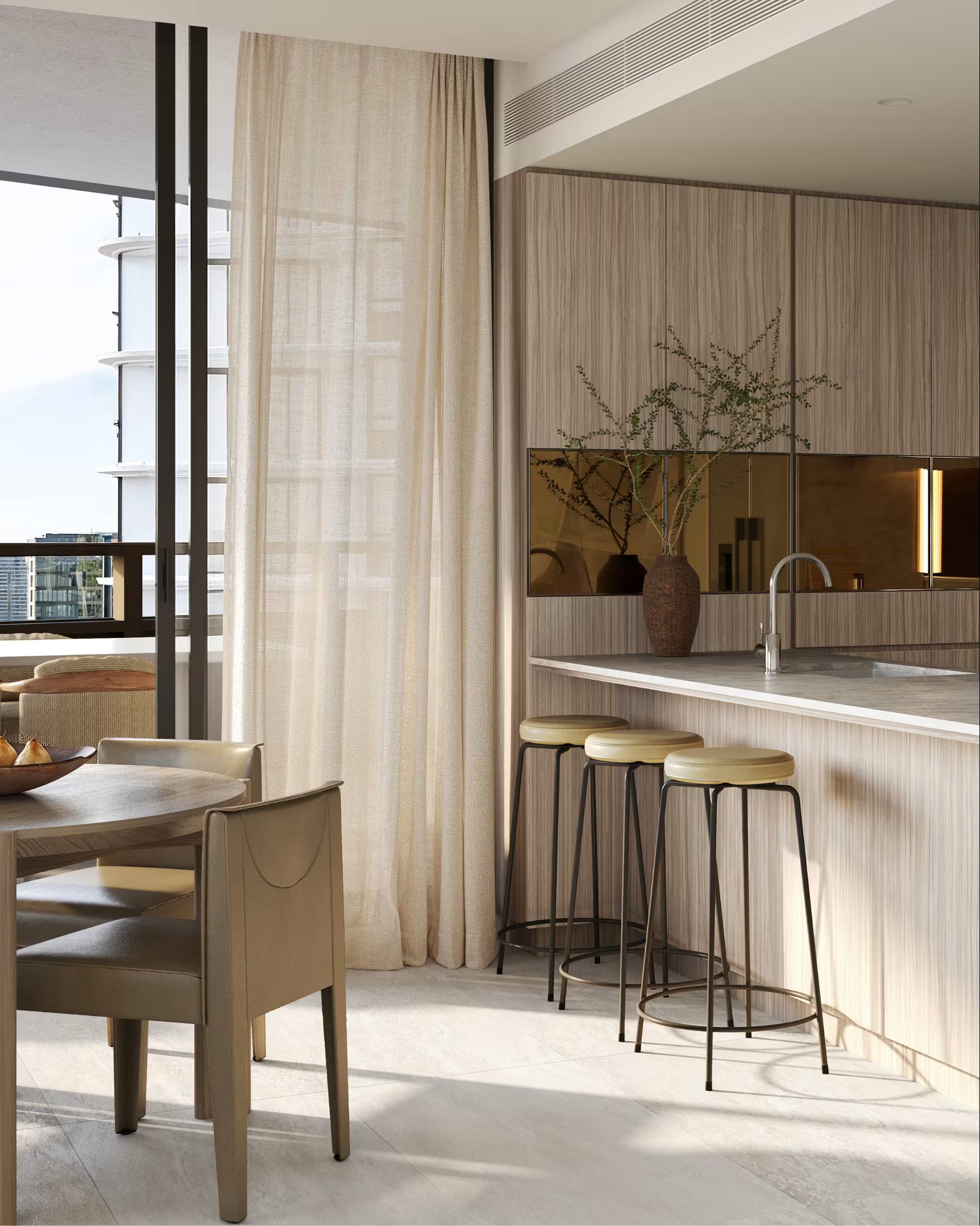 Modern kitchen and dining area with light wood cabinetry, a marble countertop, and bar stools next to a large window with sheer curtains, overlooking a cityscape.