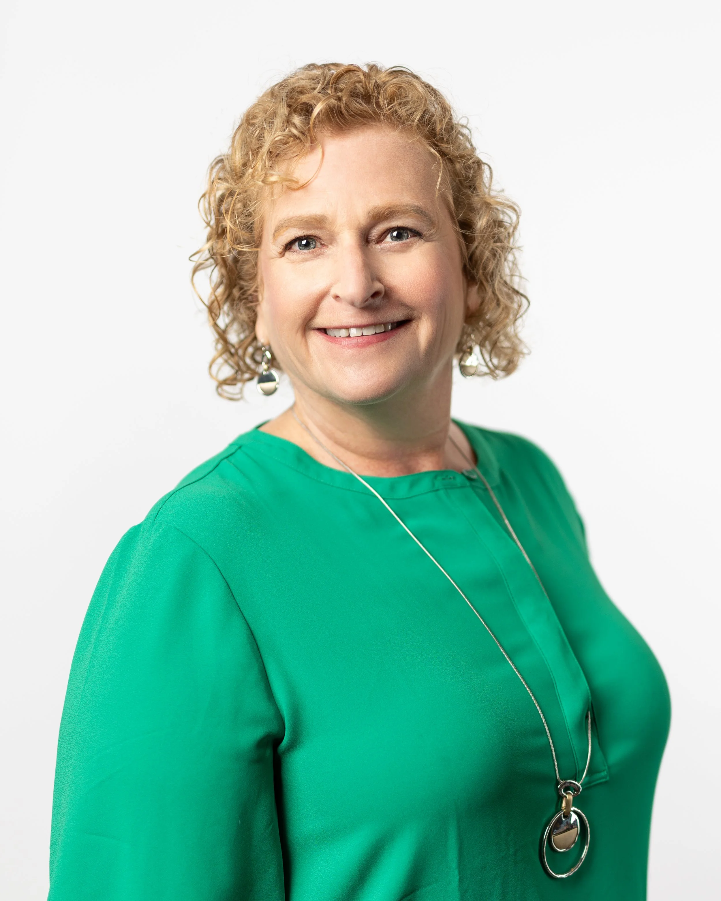 Headshot of Jill Kirson in a bright green blouse