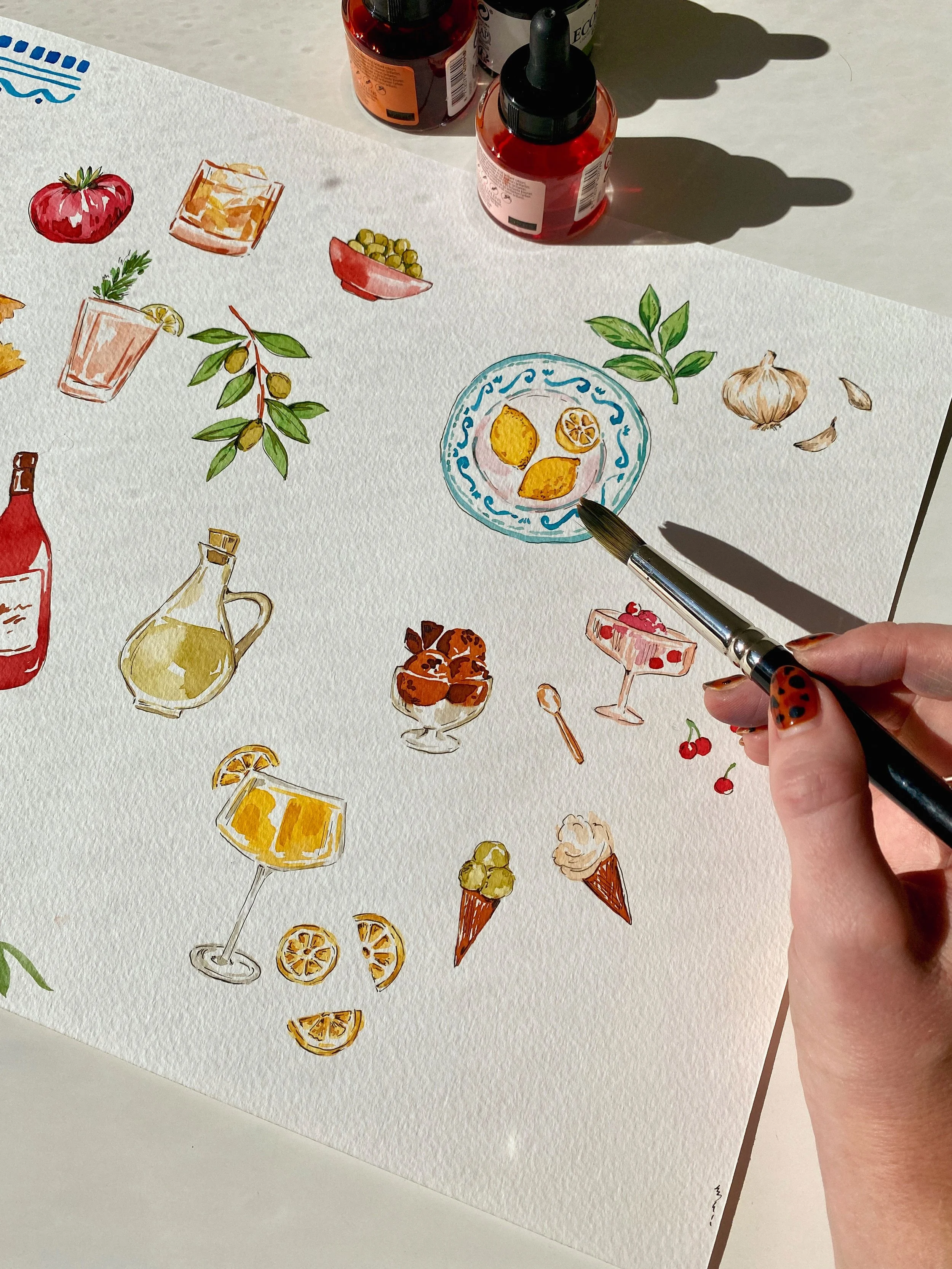 Watercolor painting of various Italian themed beverages and food items, including cocktails, lemon slices, olives, garlic, and ice cream cones, on textured paper.
