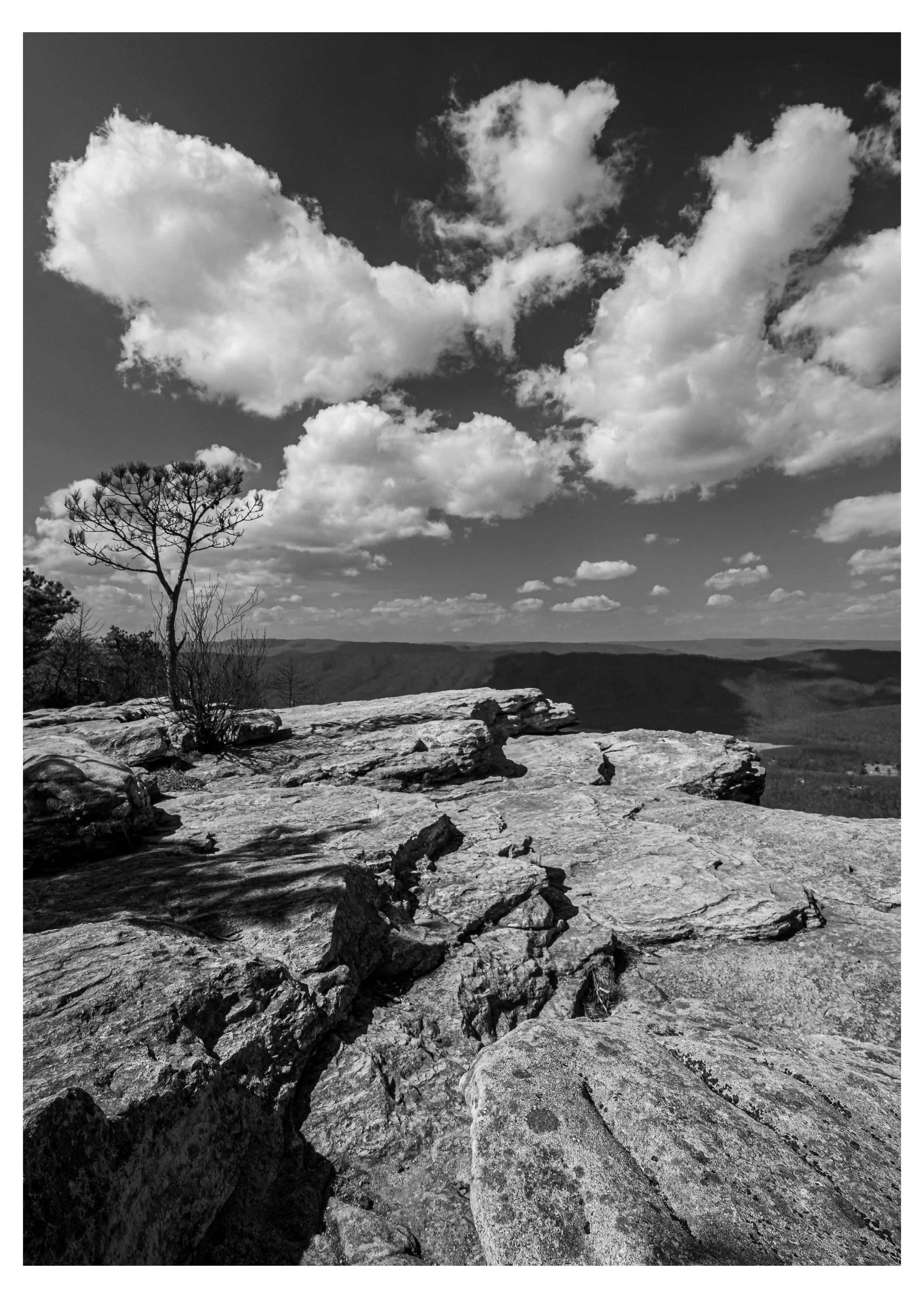 An alternative black and white photo and perspective of McAfee's Knob, with a cloudy sky, along the Appalachian Trail in Virginia.