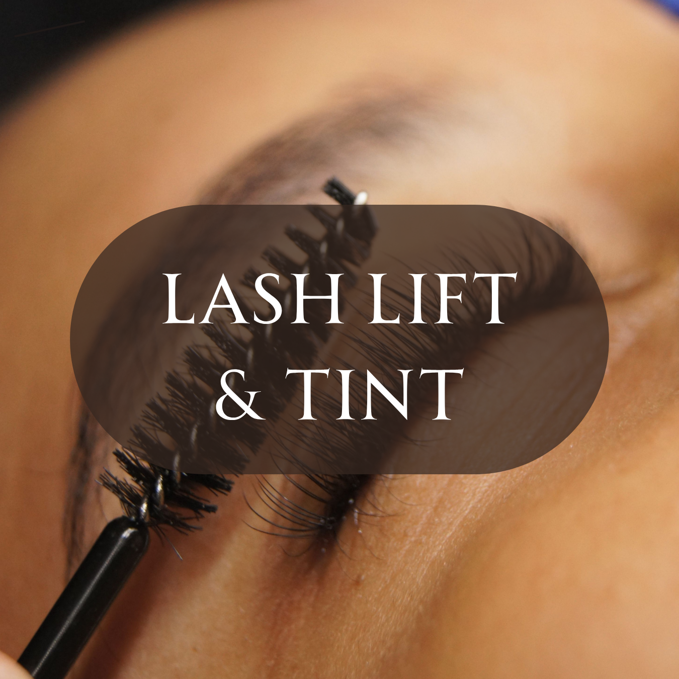 Mascara wand brushing lifted, tinted natural eyelashes during a lash lift and tint