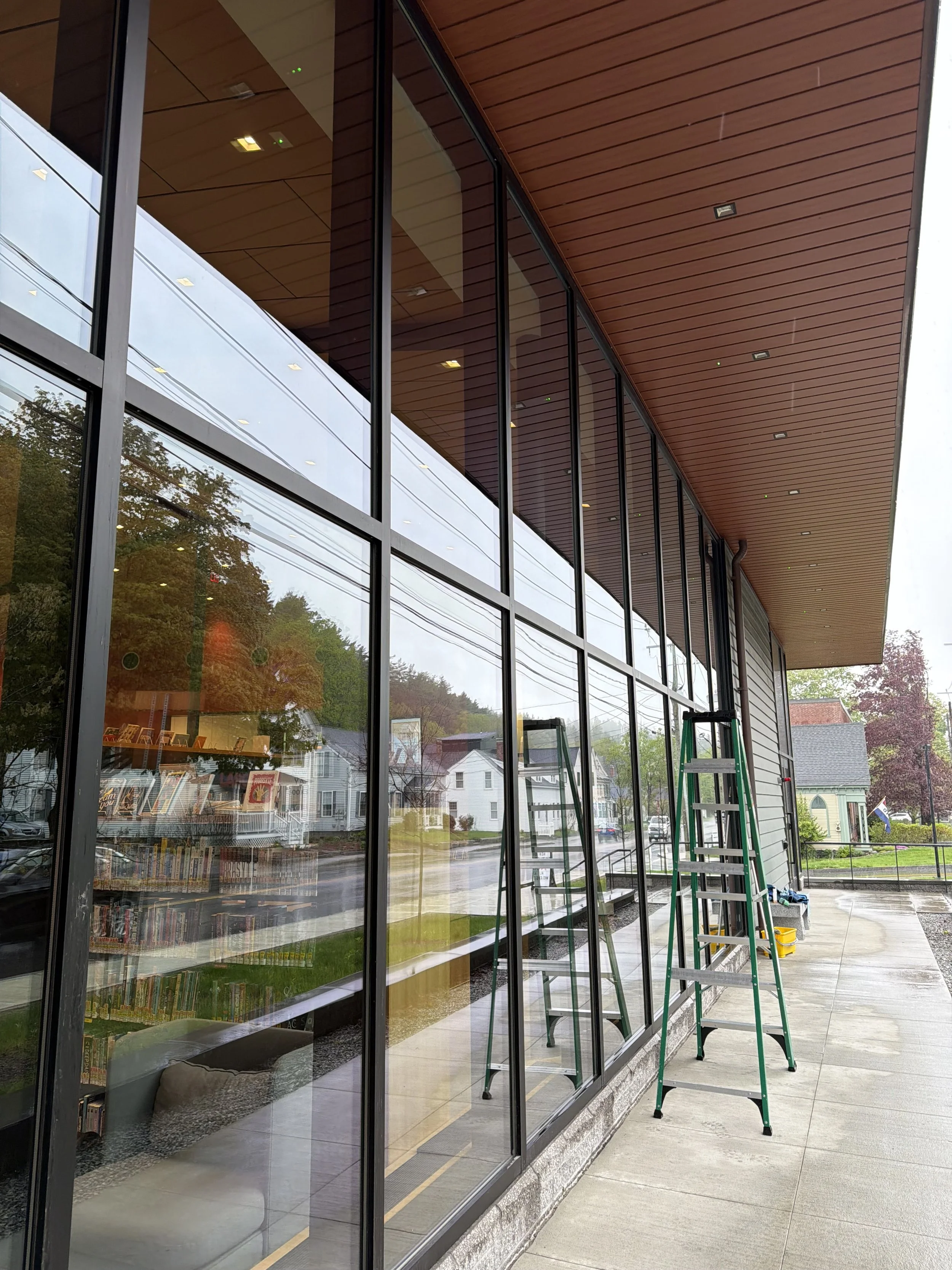 clean windows in a library with a ladder visible to show the job being done