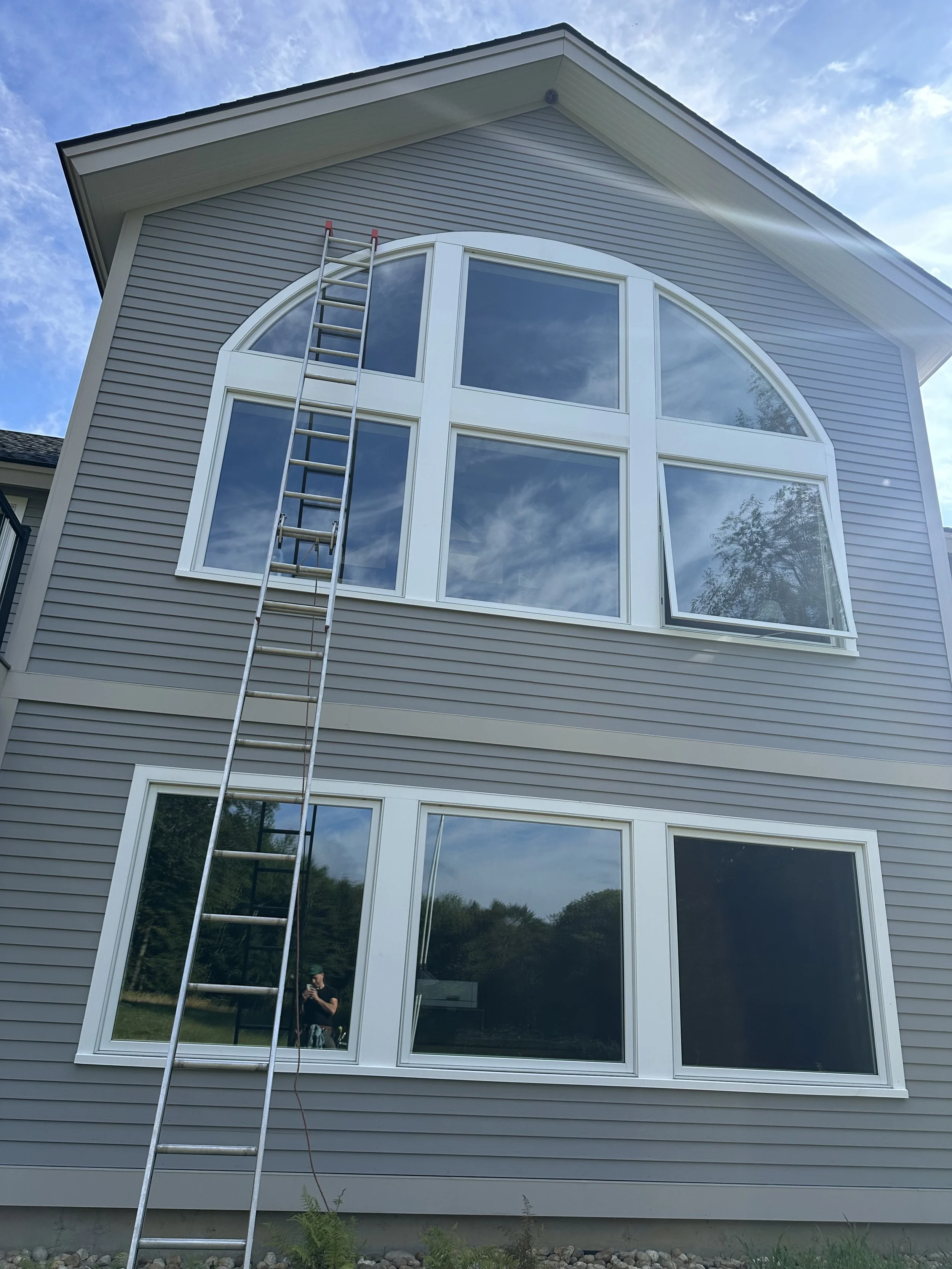 clean windows reflecting a blue sky and clouds