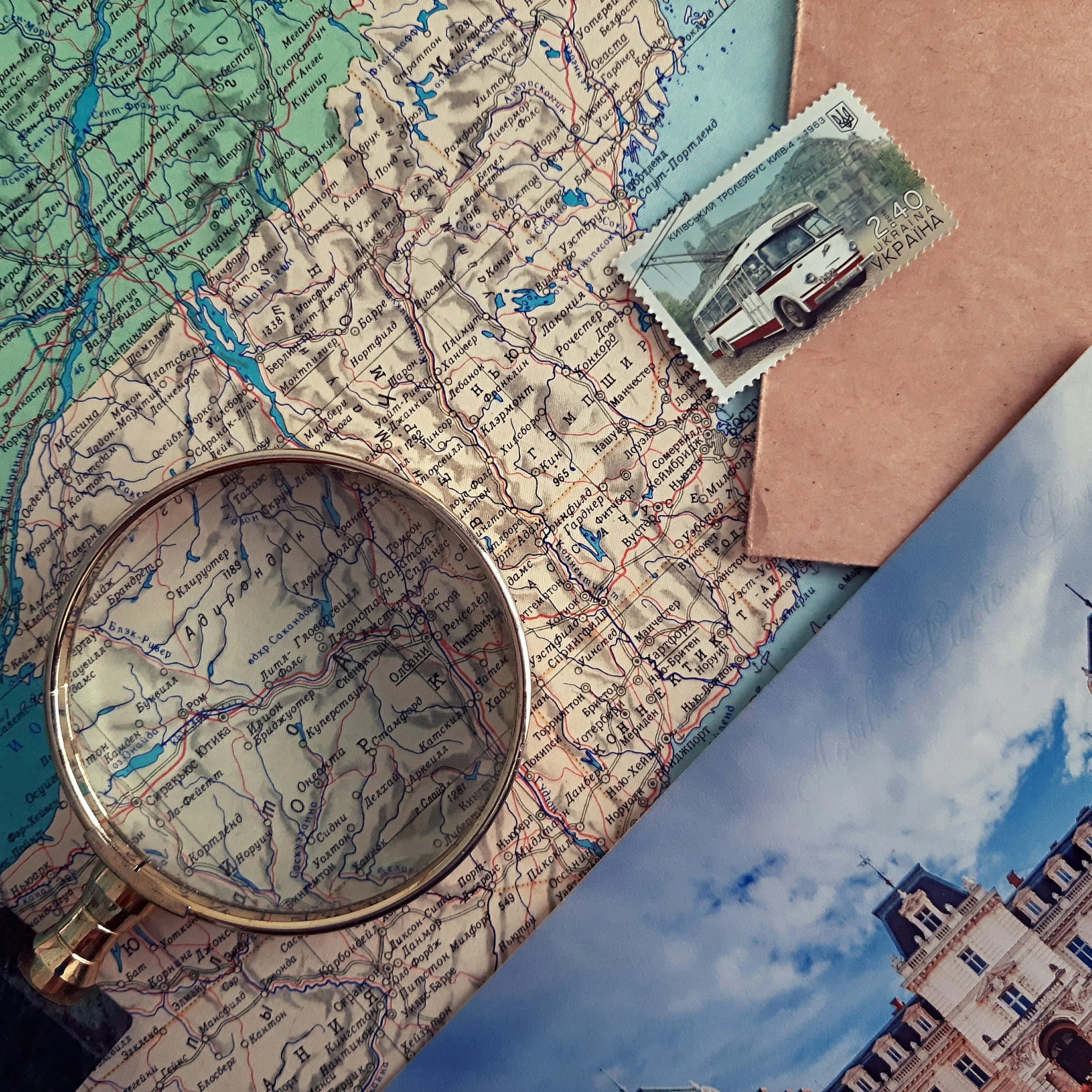 Close-up of a detailed map of Ukraine with a vintage Kyiv city bus ticket placed on it and a LEGO building in the corner.