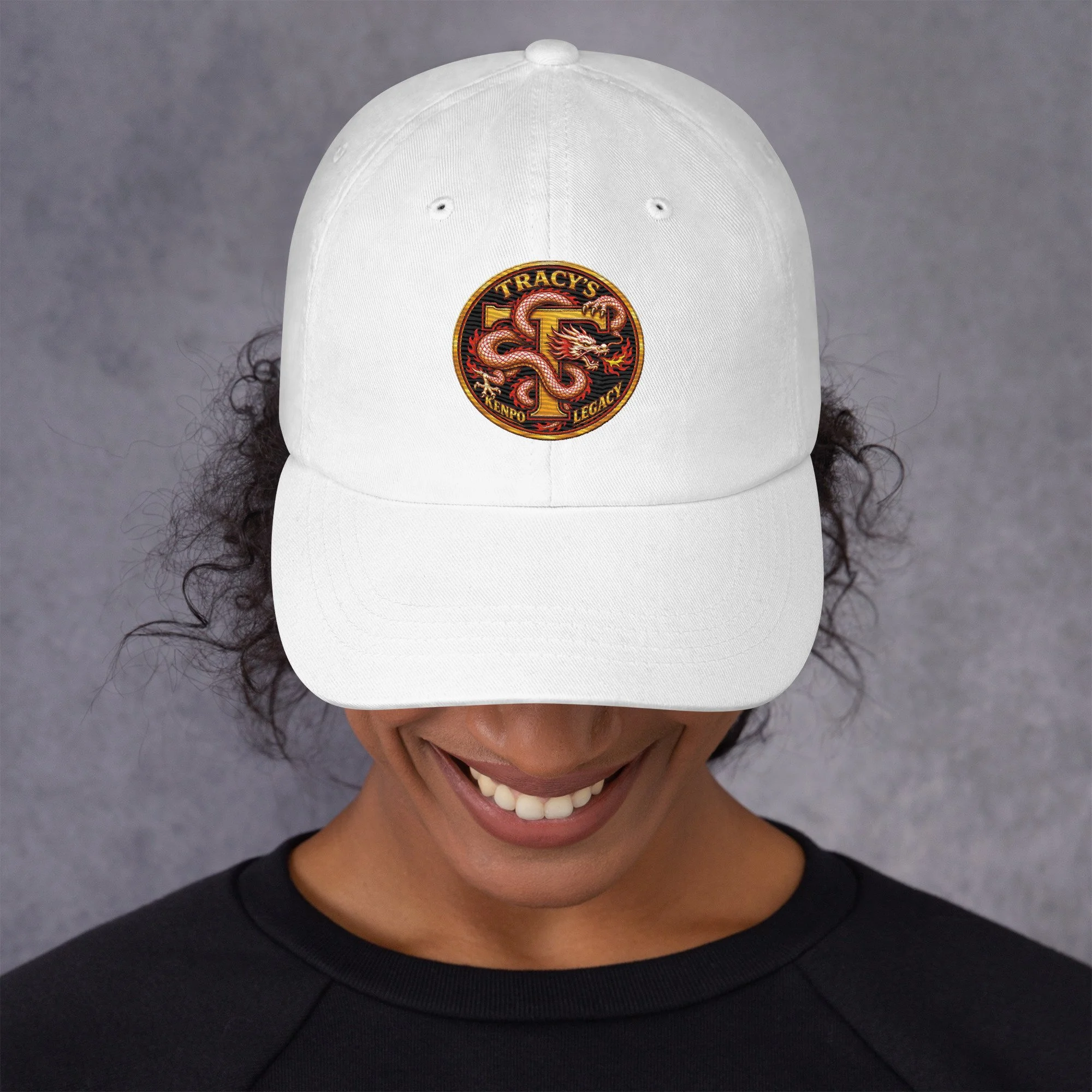 White Tracy’s Kenpo Legacy dad hat worn by a model, front view of the embroidered dragon logo.