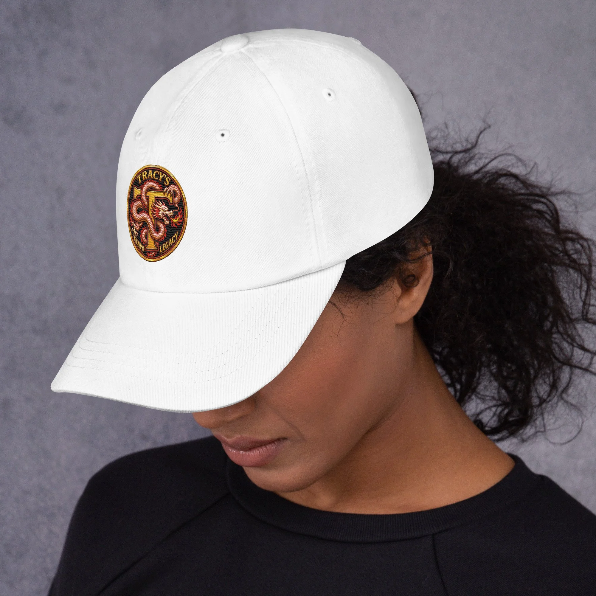 White Tracy’s Kenpo Legacy dad hat worn by a model, left-side view of the embroidered dragon logo.